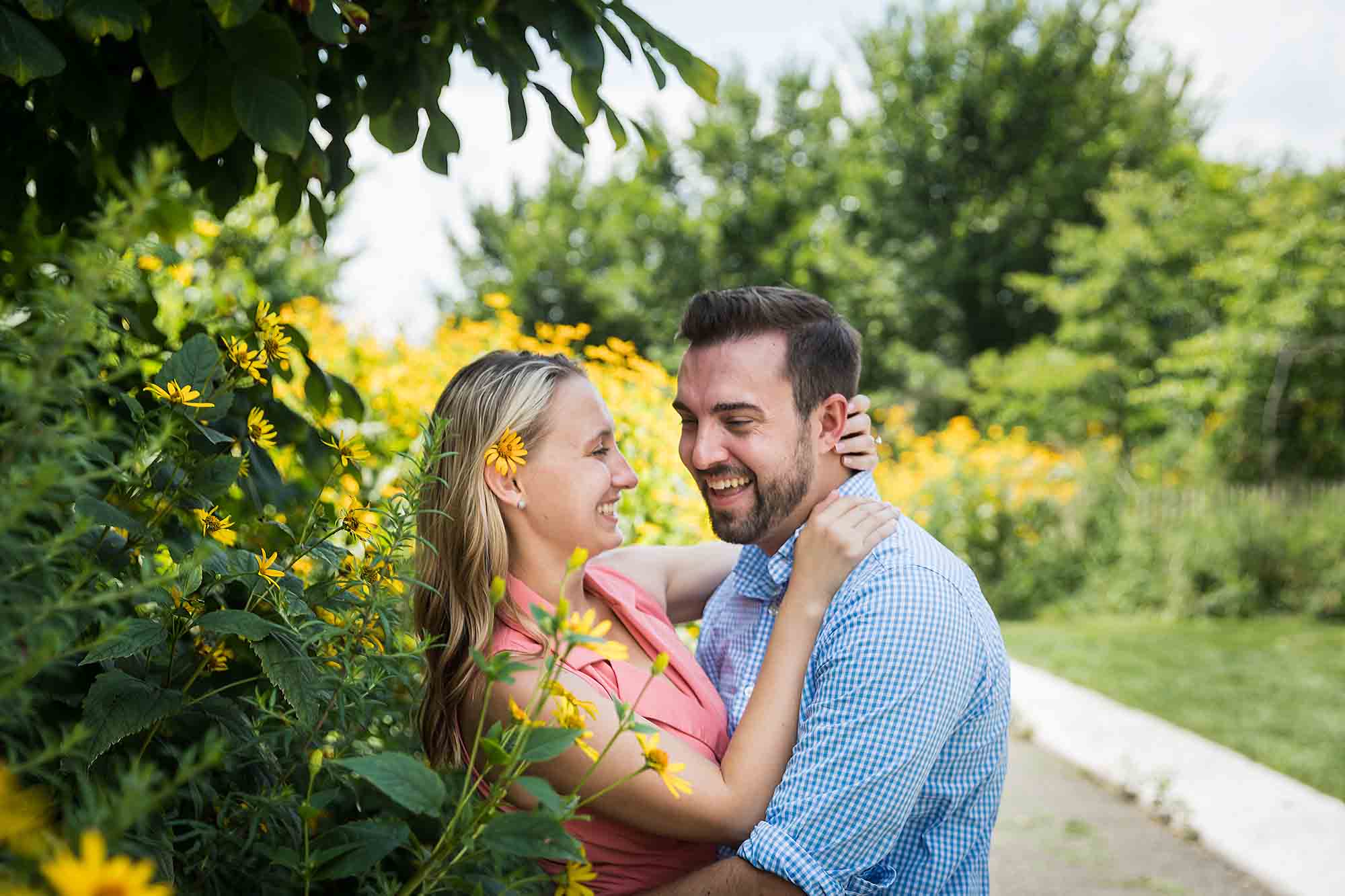 Couple hugging in Hammock Grove for an article on how to propose on Governors Island