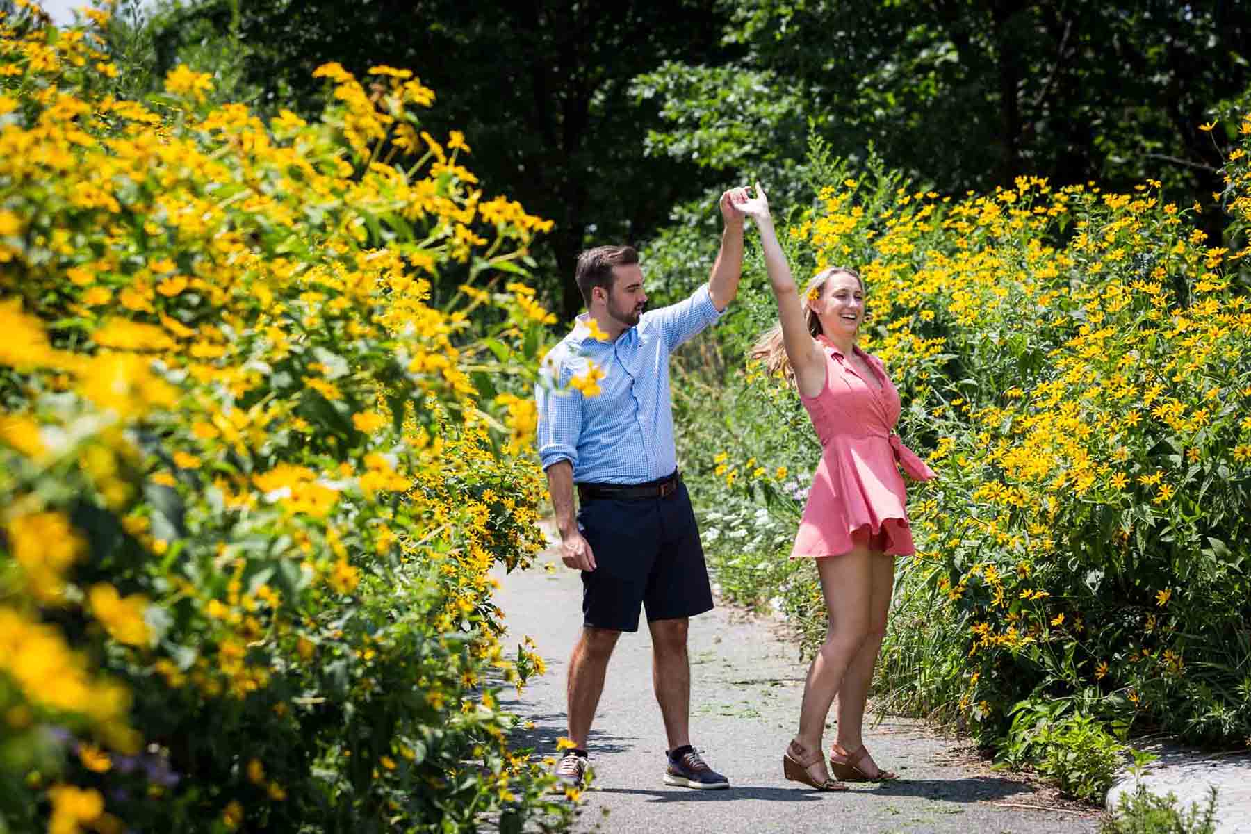 Couple dancing in front of yellow daisies