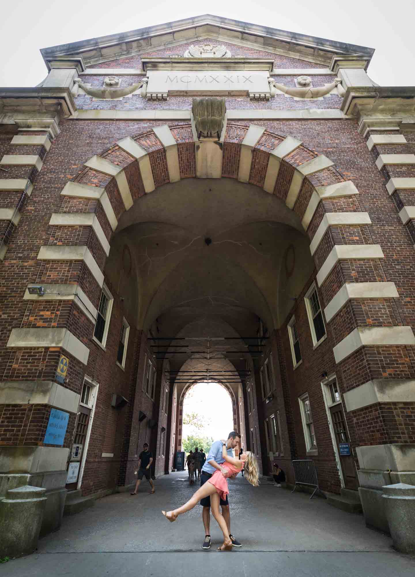 Couple dancing under Liggett Terrace archway for an article on how to propose on Governors Island