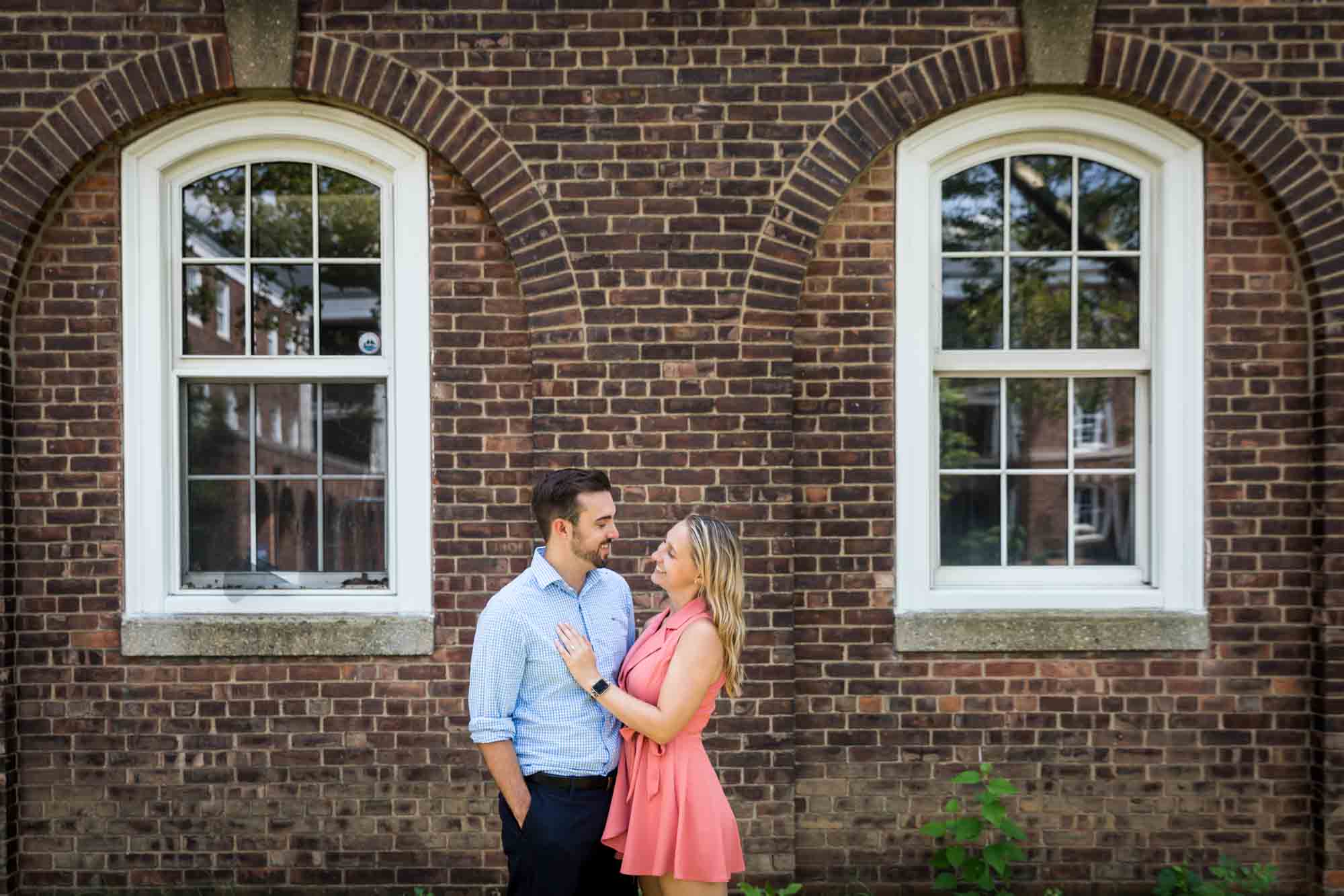 Couple in front of brick facade on Governors Island