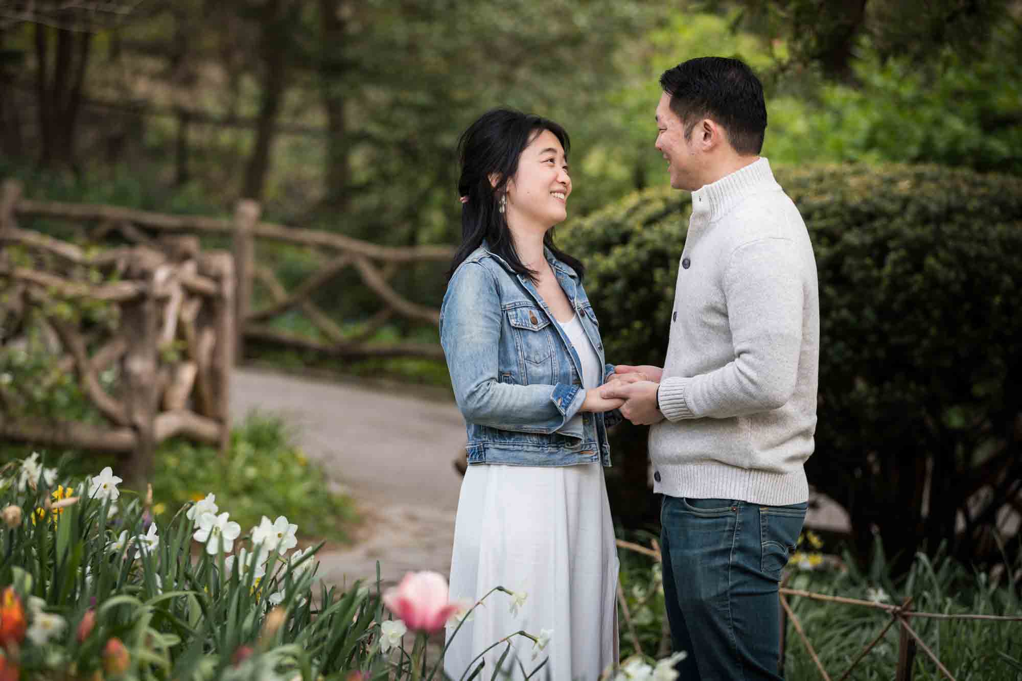 Shakespeare Garden engagement photos of a couple holding hands in the garden