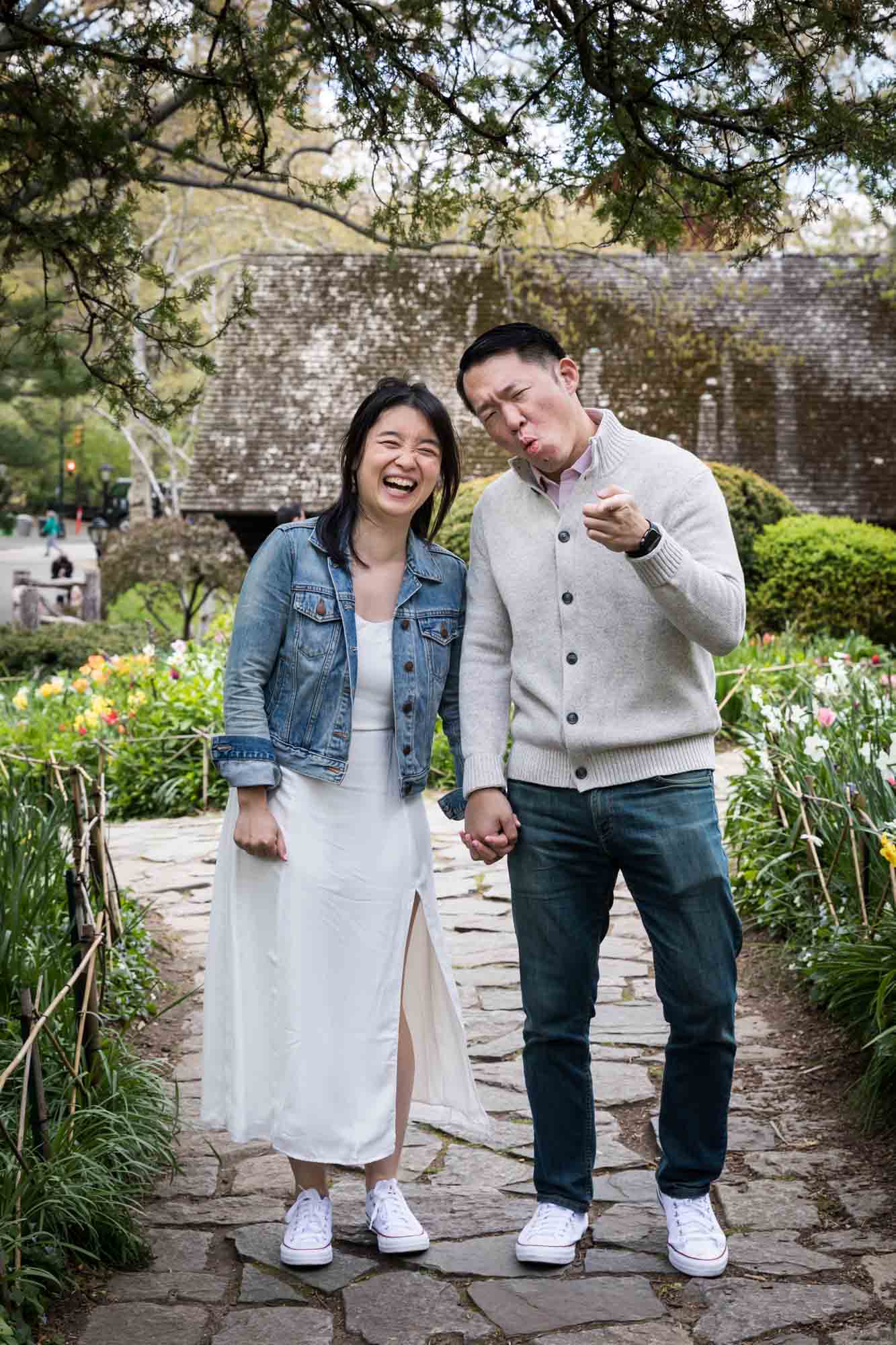 Couple making funny faces in Shakespeare Garden during engagement shoot