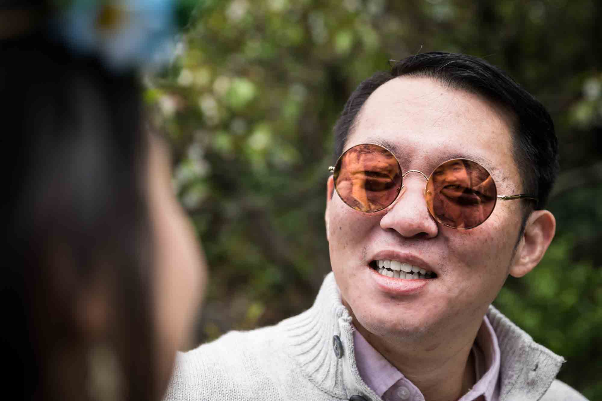 Man wearing Beatle-style sunglasses