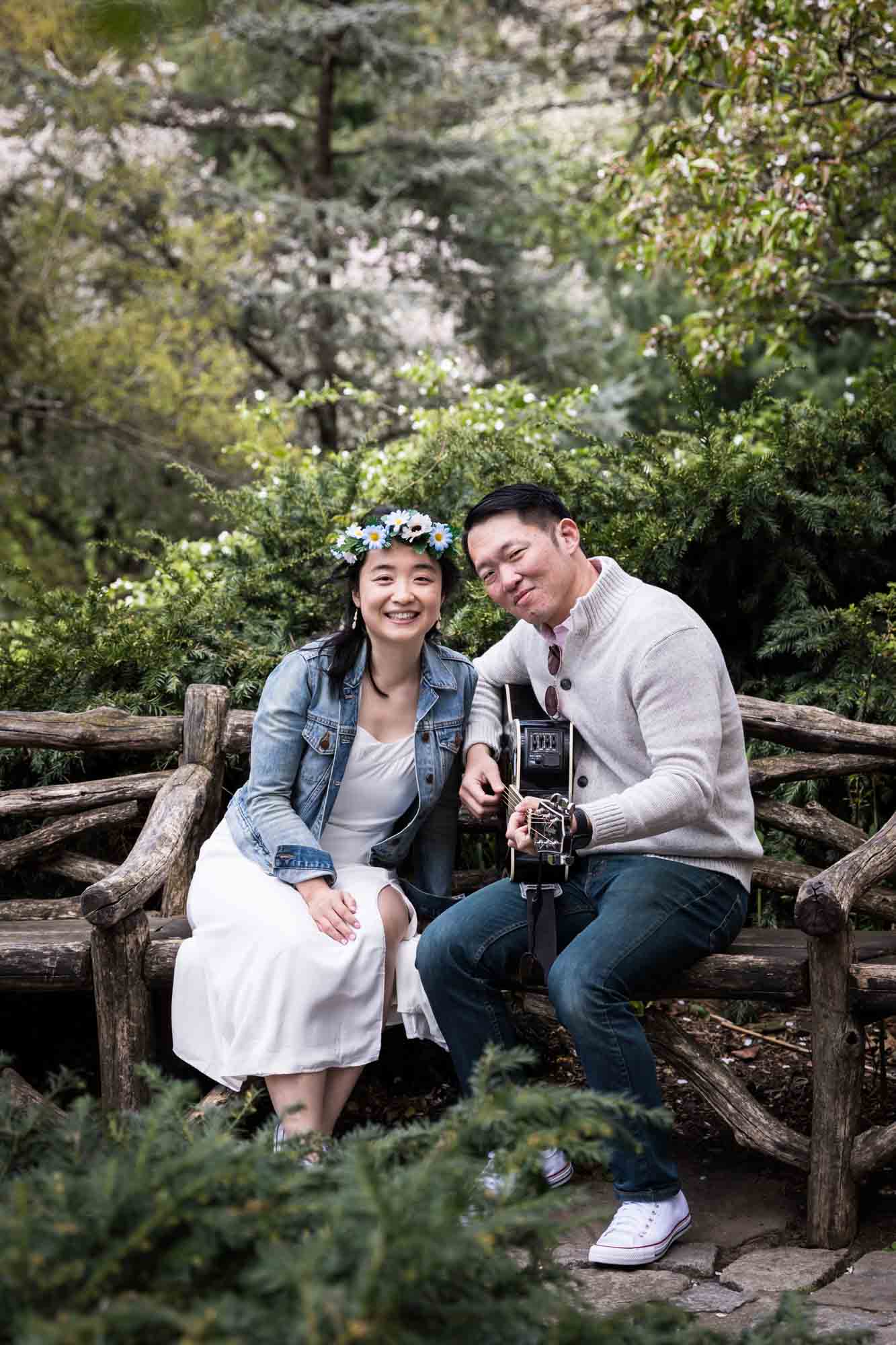 Couple posing with guitar in Shakespeare Garden during engagement shoot