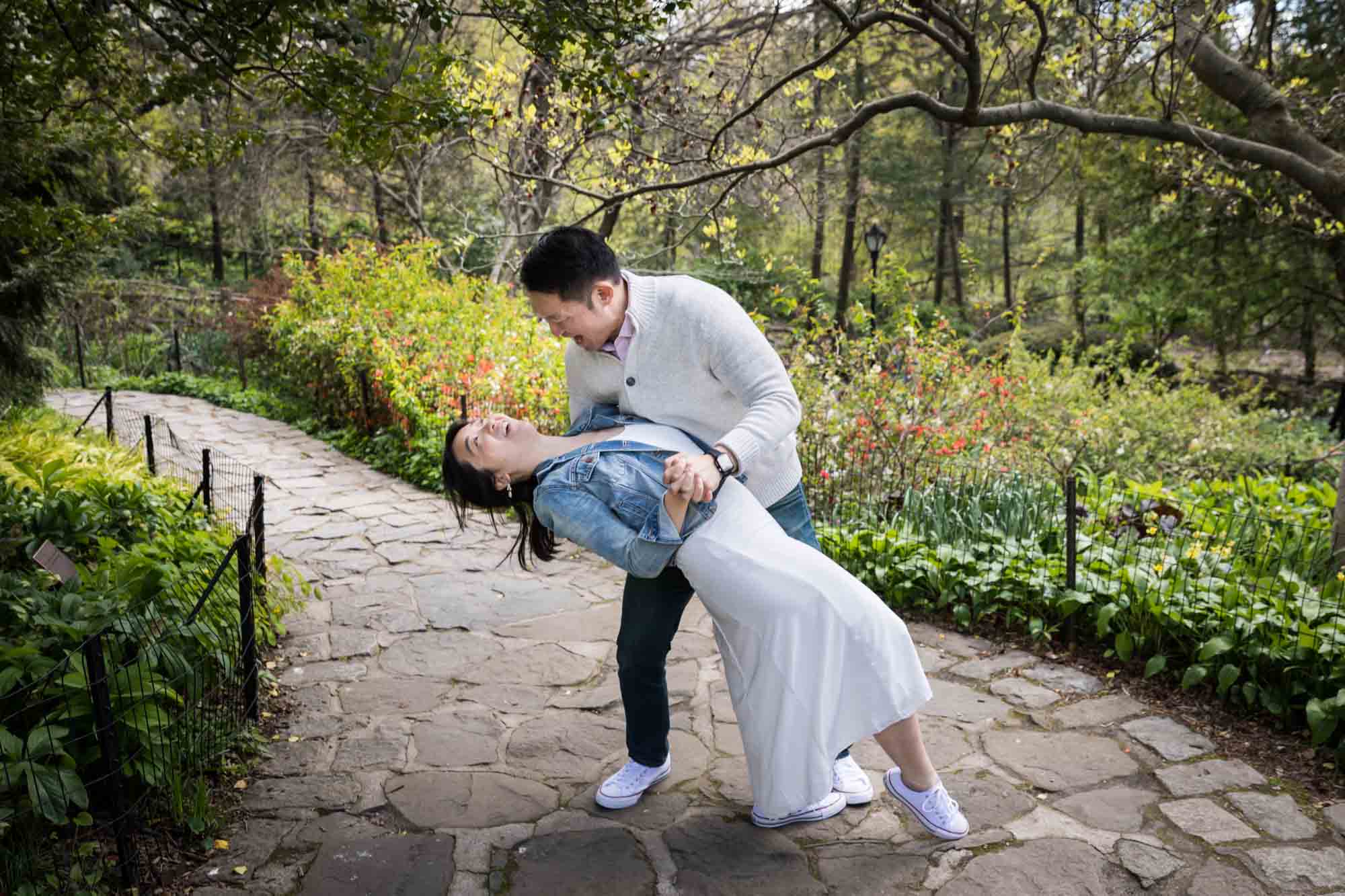 Man dipping woman in dance move in middle of pathway