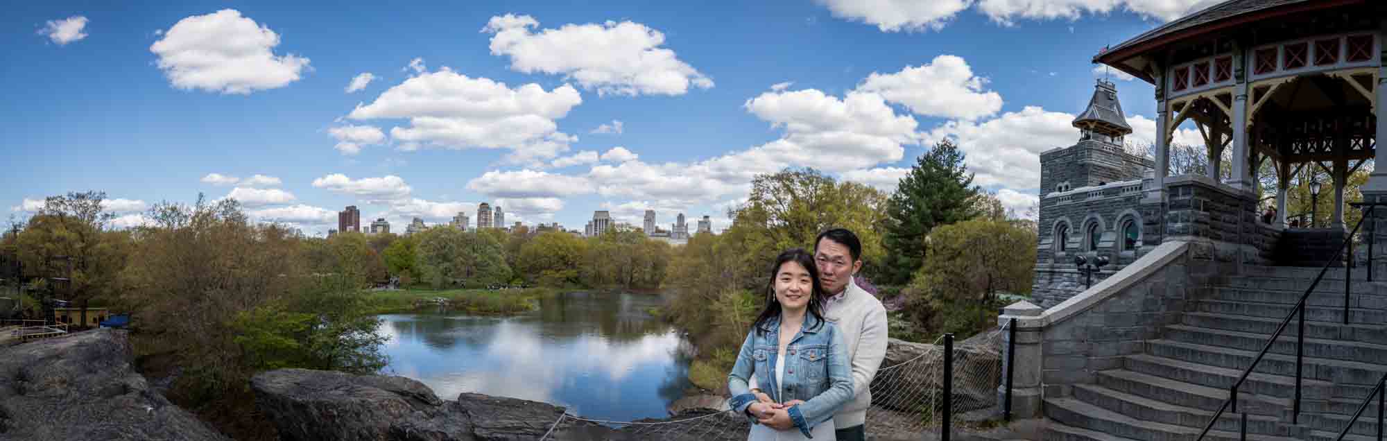 Couple hugging in front of Turtle Pond in Central Park