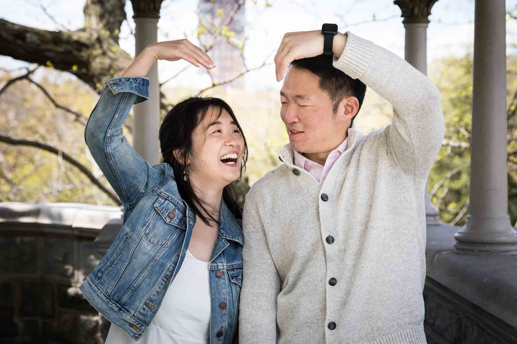 Shakespeare Garden engagement photos of couple holding arms in heart-shaped arch