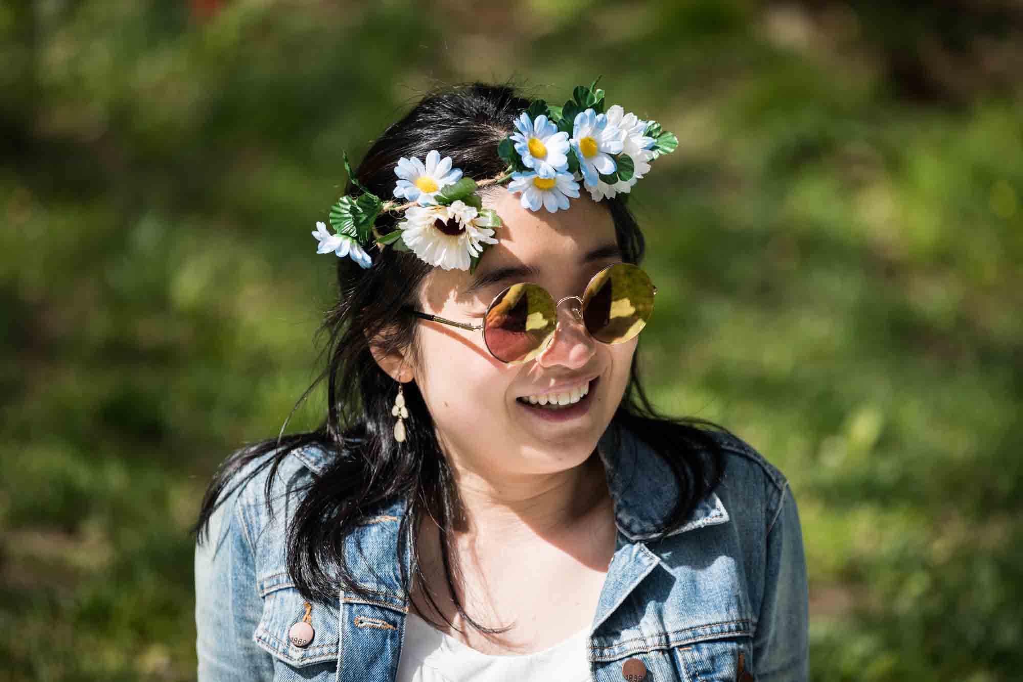 Woman wearing daisy crown and Beatles-style sunglasses
