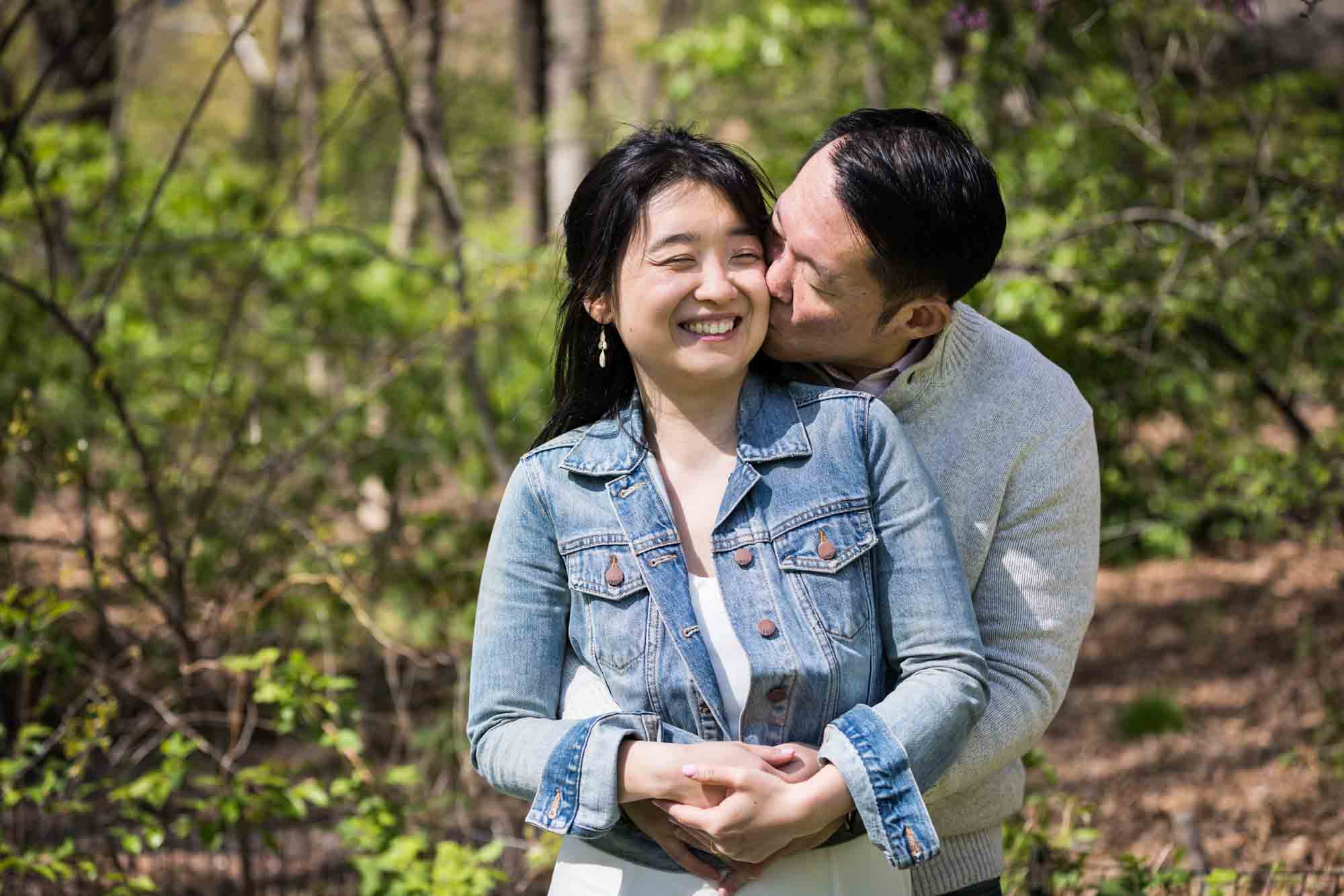 Man kissing woman's cheek in Central Park