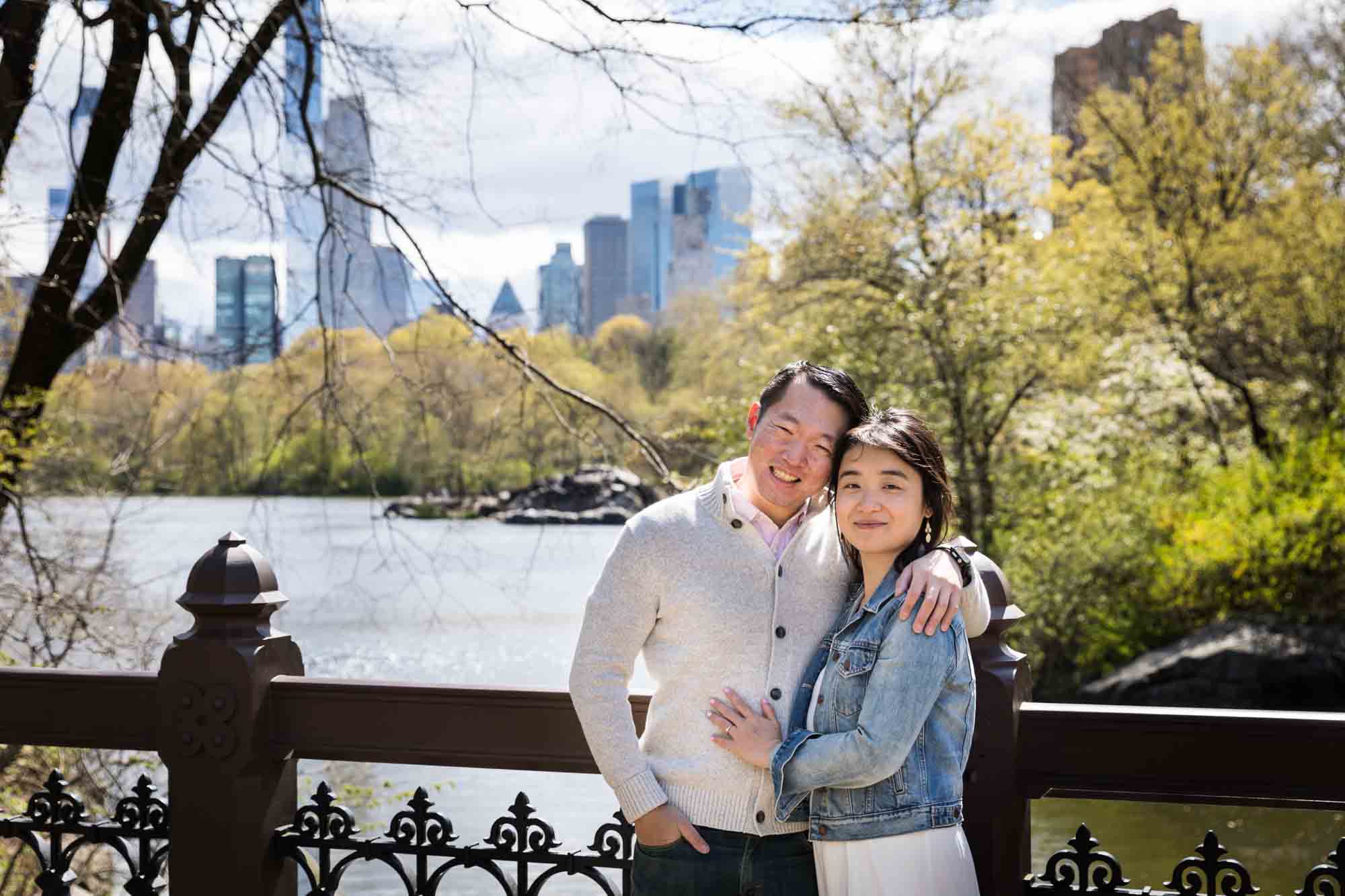 Couple hugging on Oak Bridge in Central Park