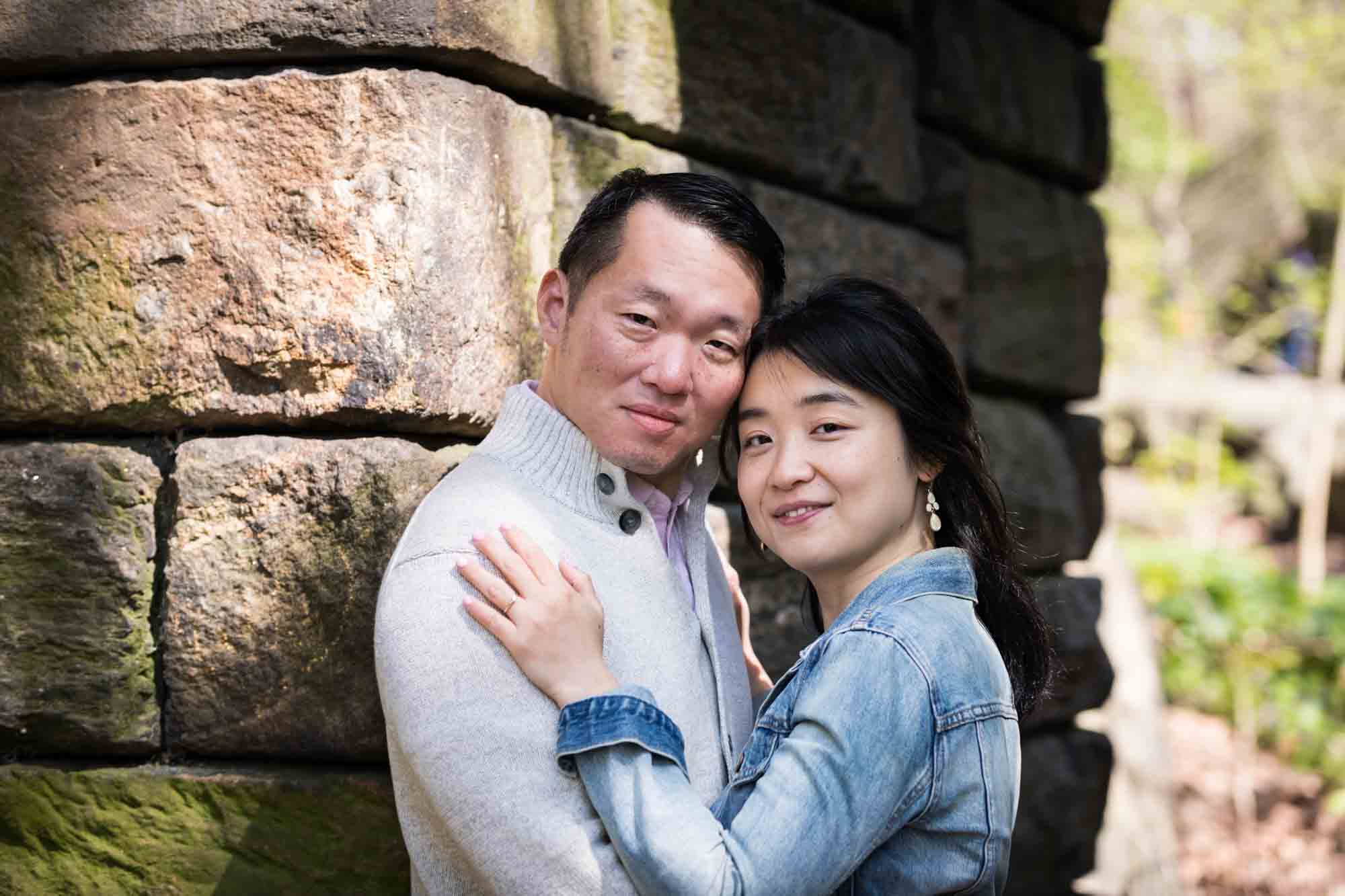 Couple hugging in front of the Stone Arch in the Ramble