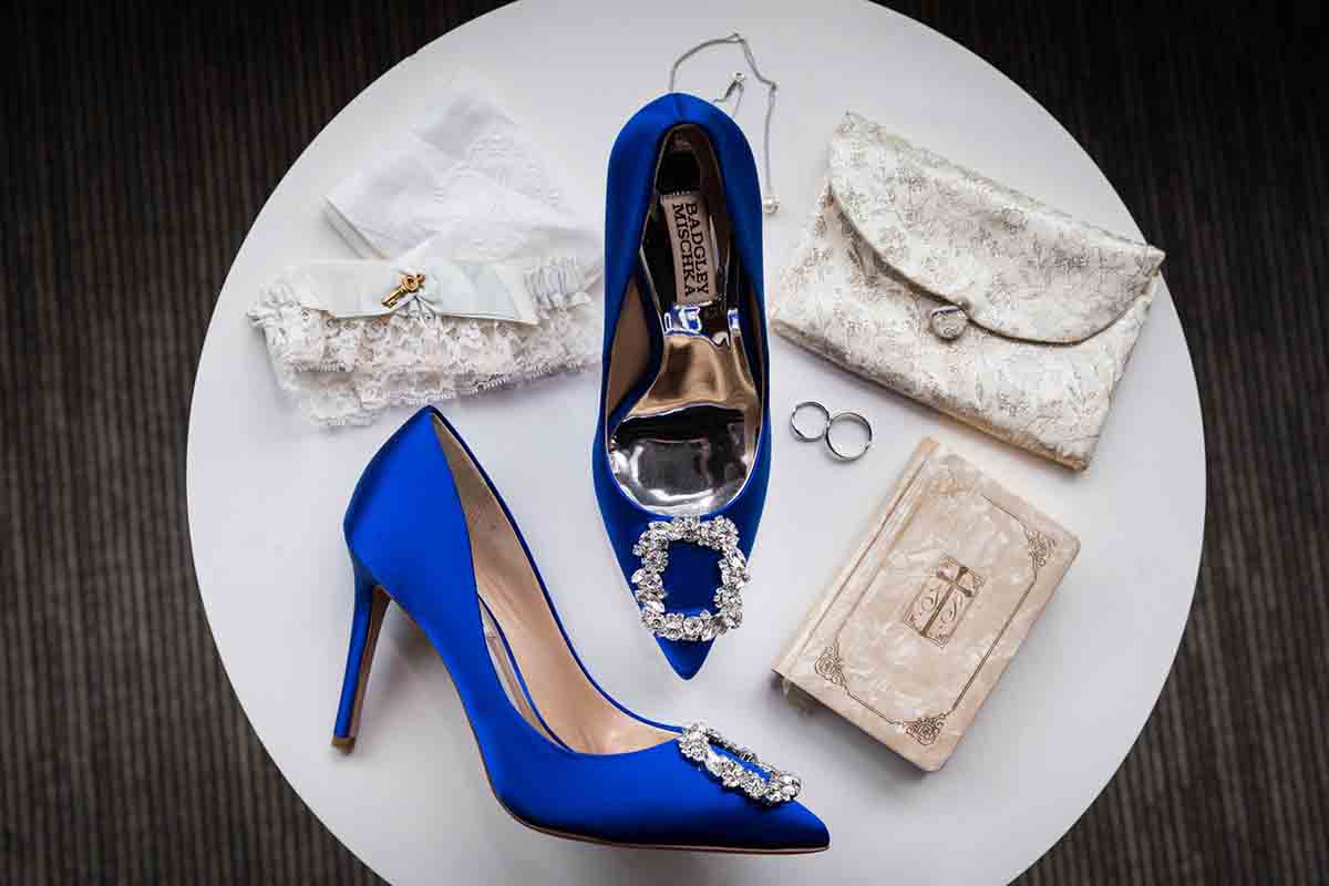Top down view of blue high heels and wedding accessories