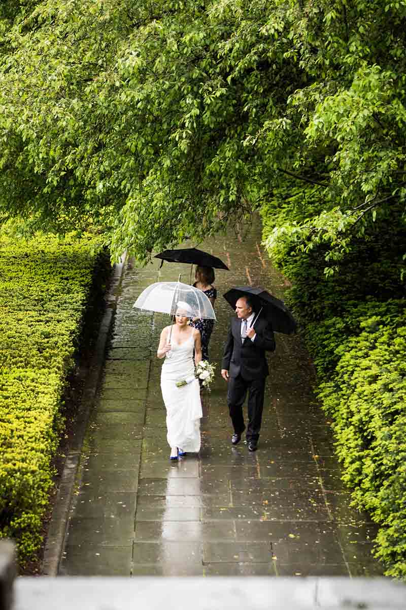 Central Park Wisteria Pergola wedding photos of bride and parents walking down pathway