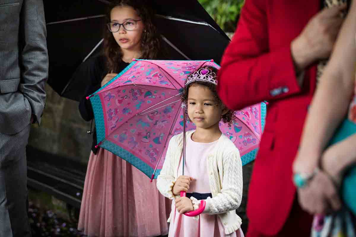 Central Park Wisteria Pergola wedding photos of little girl wearing tiara and holding pink umbrella