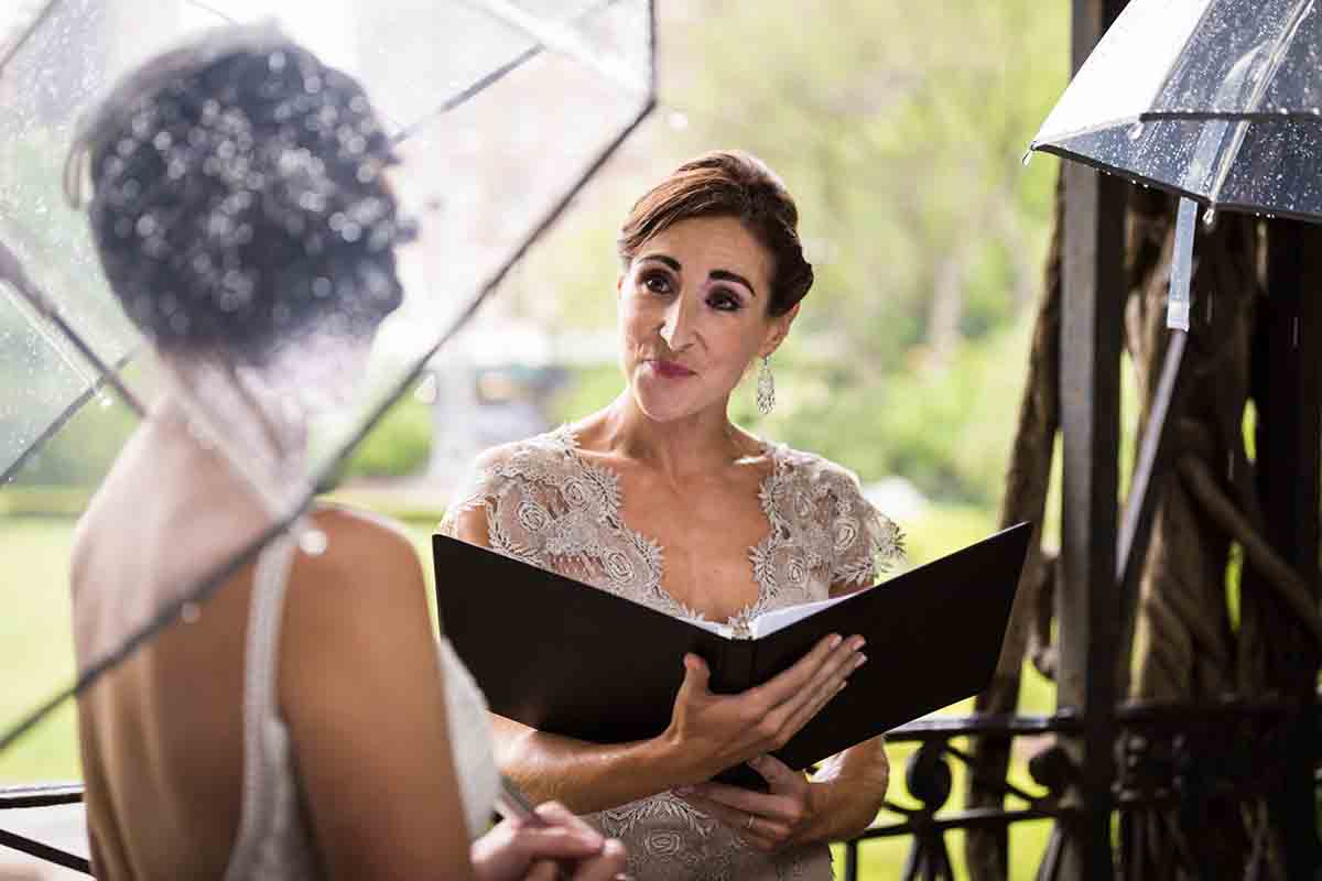 Central Park Wisteria Pergola wedding photos of female officiant holding notebook