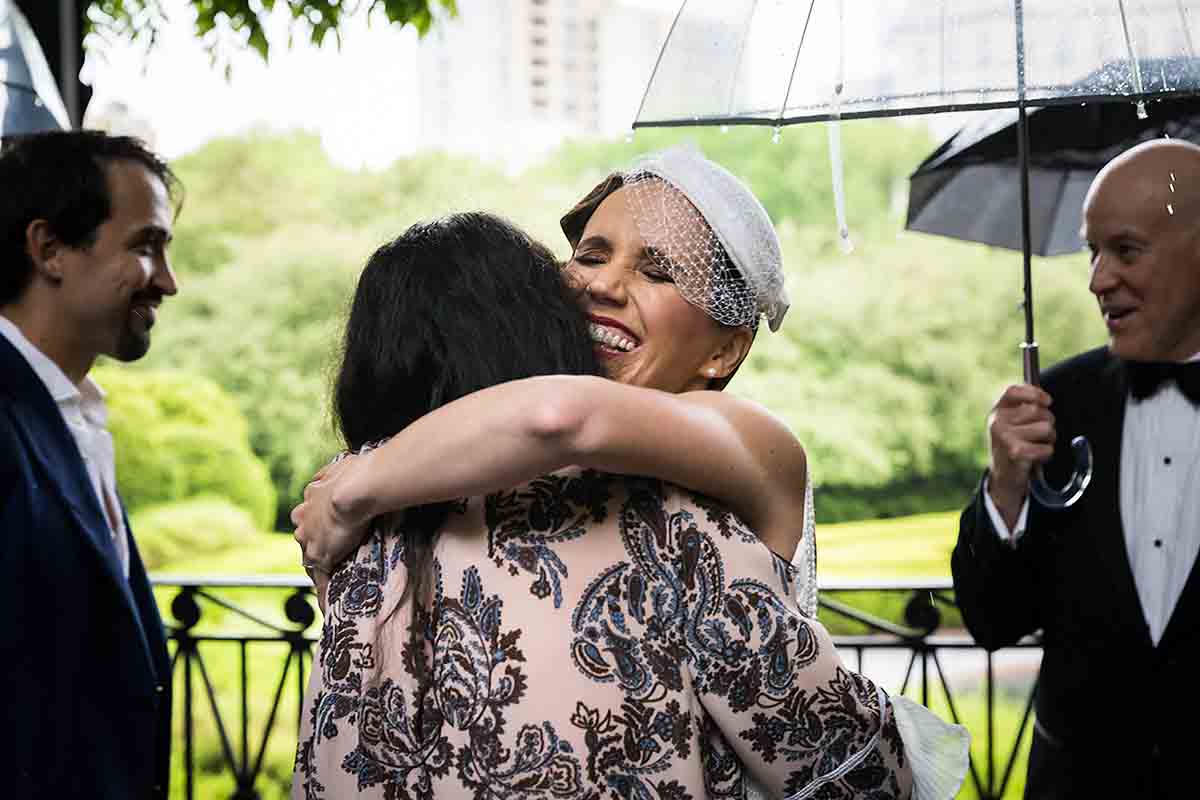 Central Park Wisteria Pergola wedding photos of bride hugging a guest