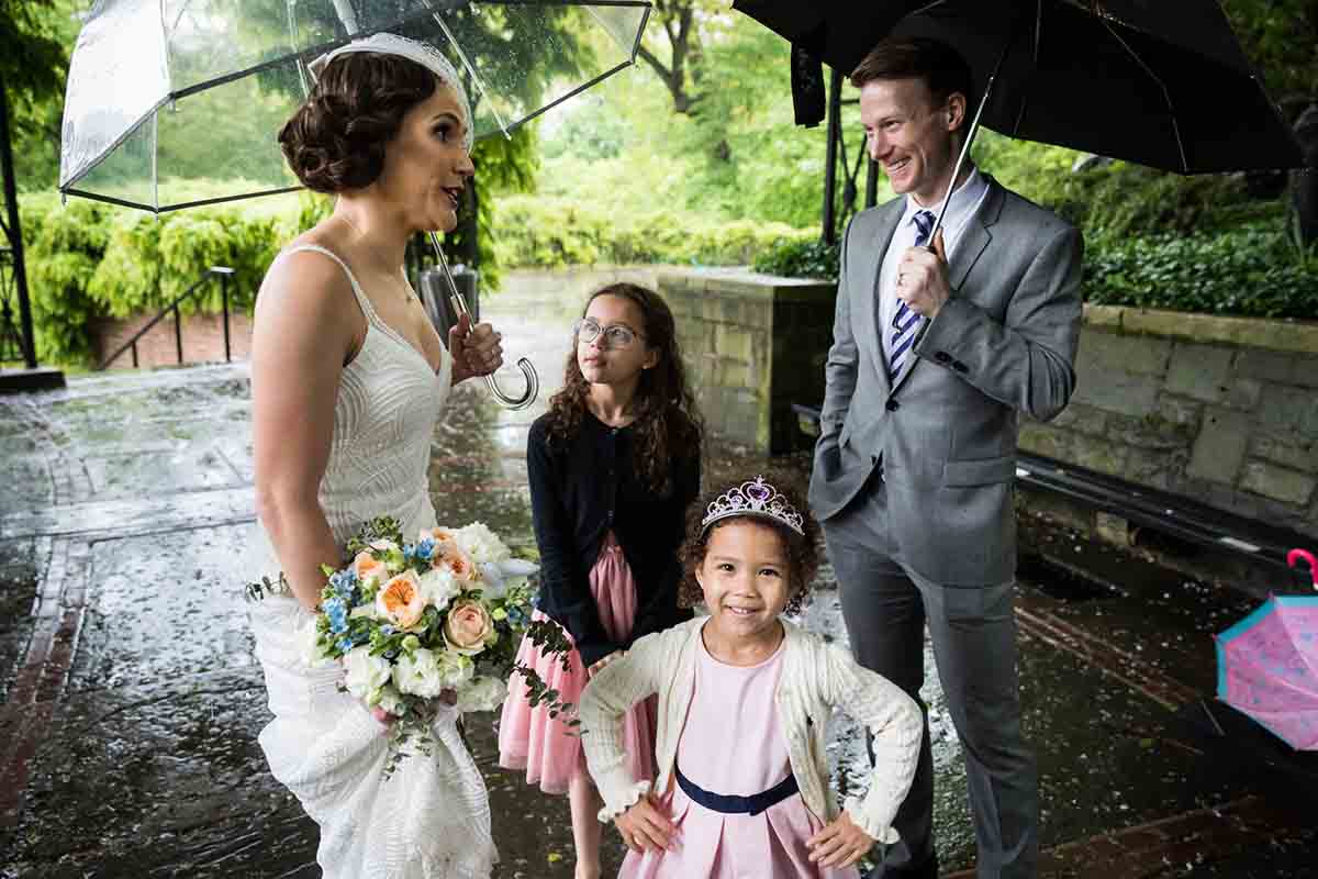 Central Park Wisteria Pergola wedding photos of little girl with hands on hips in front of bride and guests