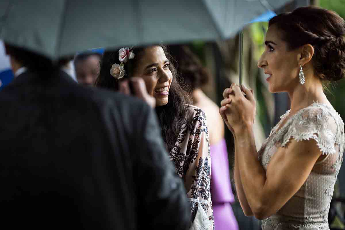 Central Park Wisteria Pergola wedding photos of guests holding umbrellas