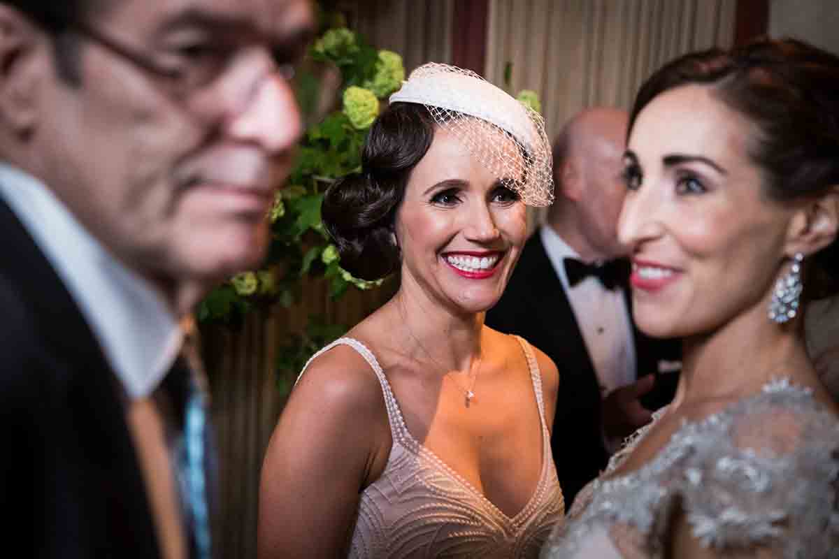 Gramercy Tavern wedding reception photos of bride wearing white hat with veil with two guests