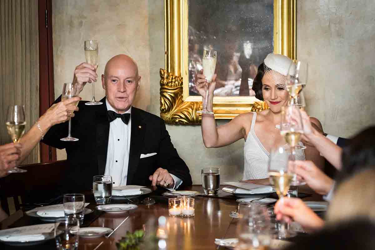 Gramercy Tavern wedding reception photos of bride and groom raising wine glasses for toasts