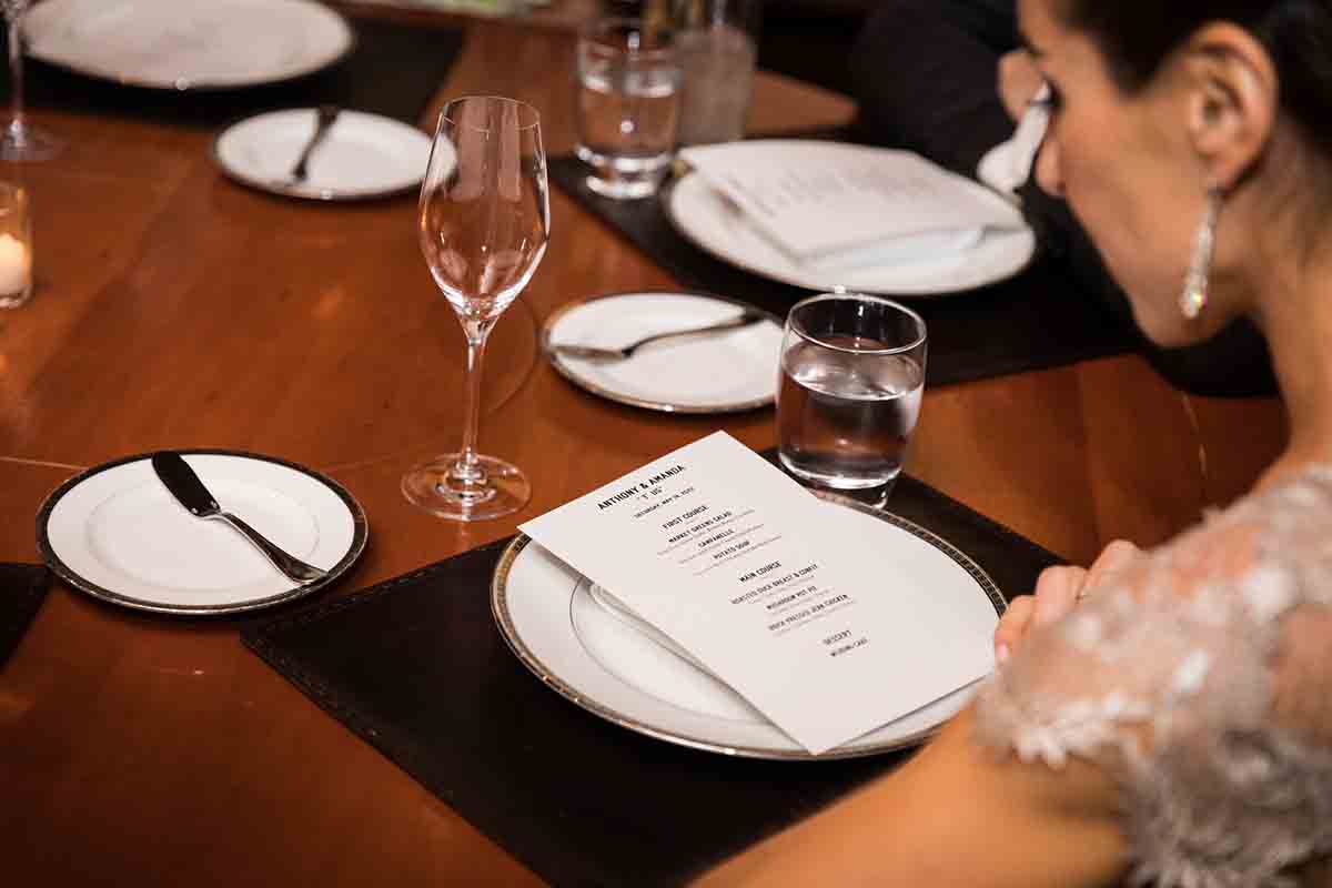 Gramercy Tavern wedding reception photos of guest reading menu on table