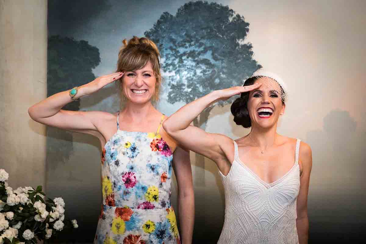 Gramercy Tavern wedding reception photos of bride and female guest saluting