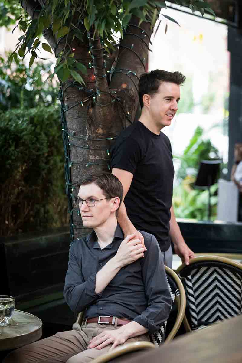 Man caressing the shoulder of another man at the High Line Hotel