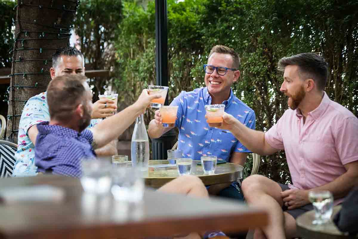 Guests toasting with cocktails outdoors at High Line Hotel