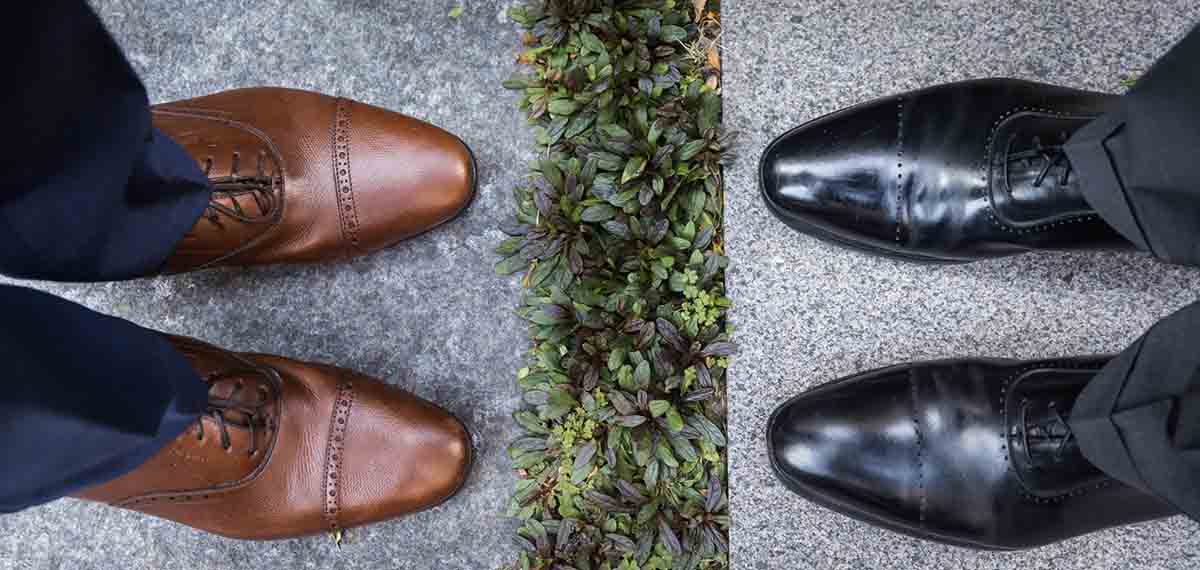 Close up shot of shoes of two men facing each other