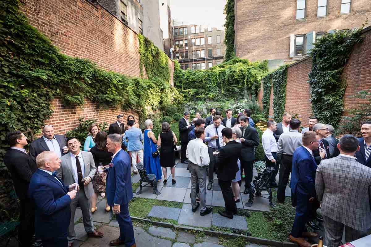 Merchant’s House Museum NYC wedding photos of guests during pre-ceremony cocktail hour in garden