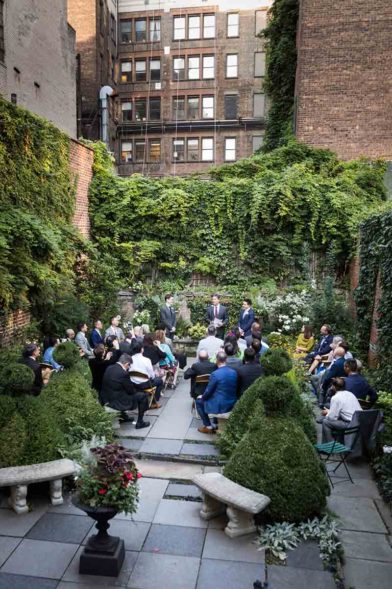Merchant’s House Museum NYC wedding photos of guests seated in garden during ceremony