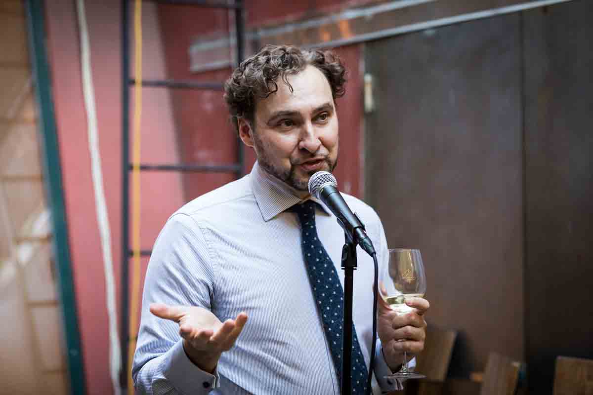 Man giving toast during wedding Il Buco Alimentari and Vineria wedding reception