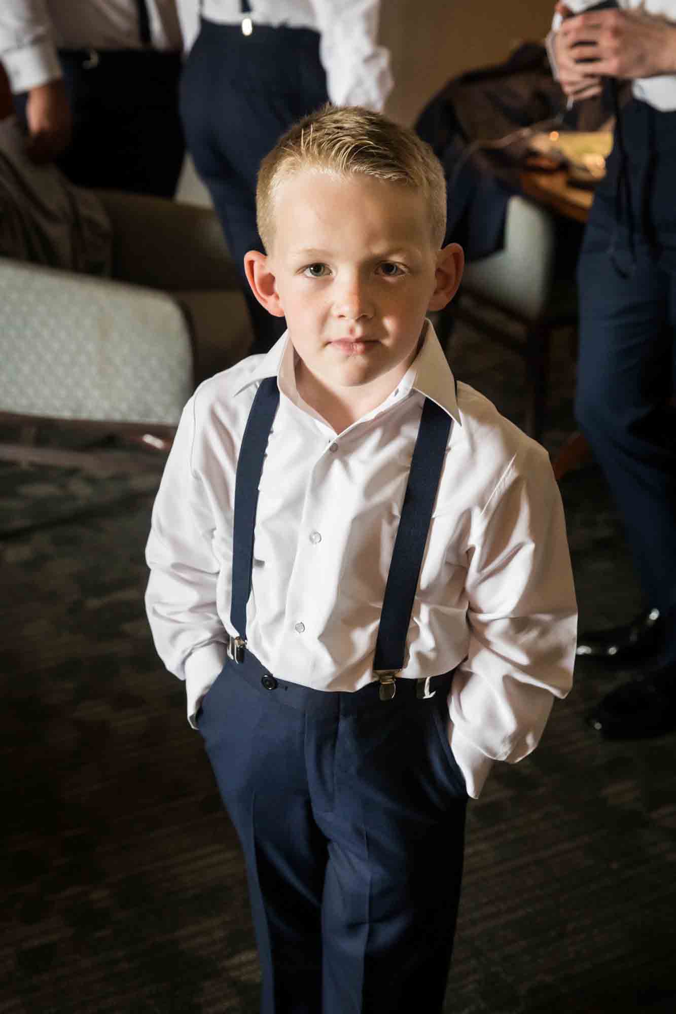 Little ring bearer standing with hands in pockets