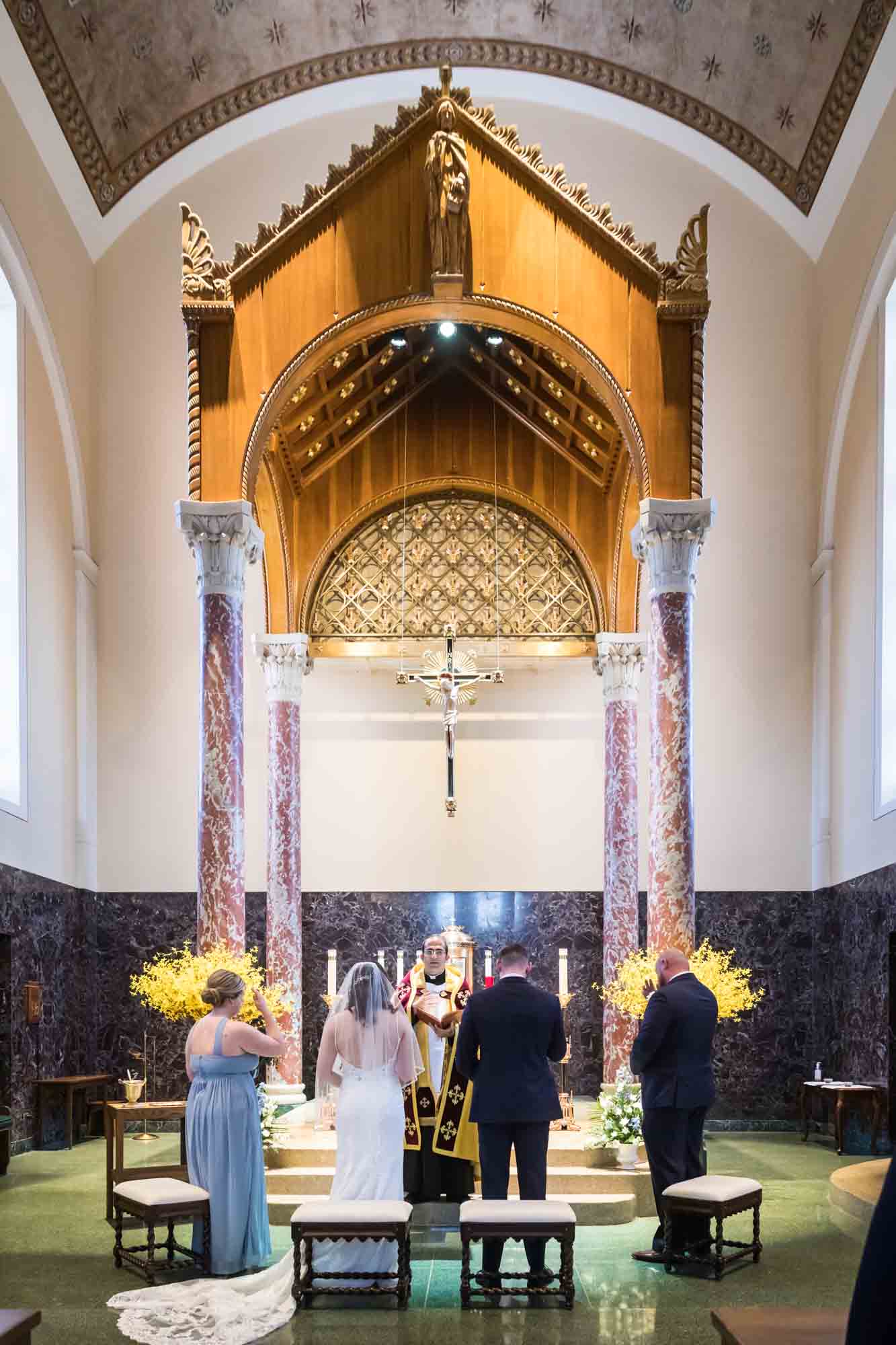 Bride and groom at altar during church ceremony