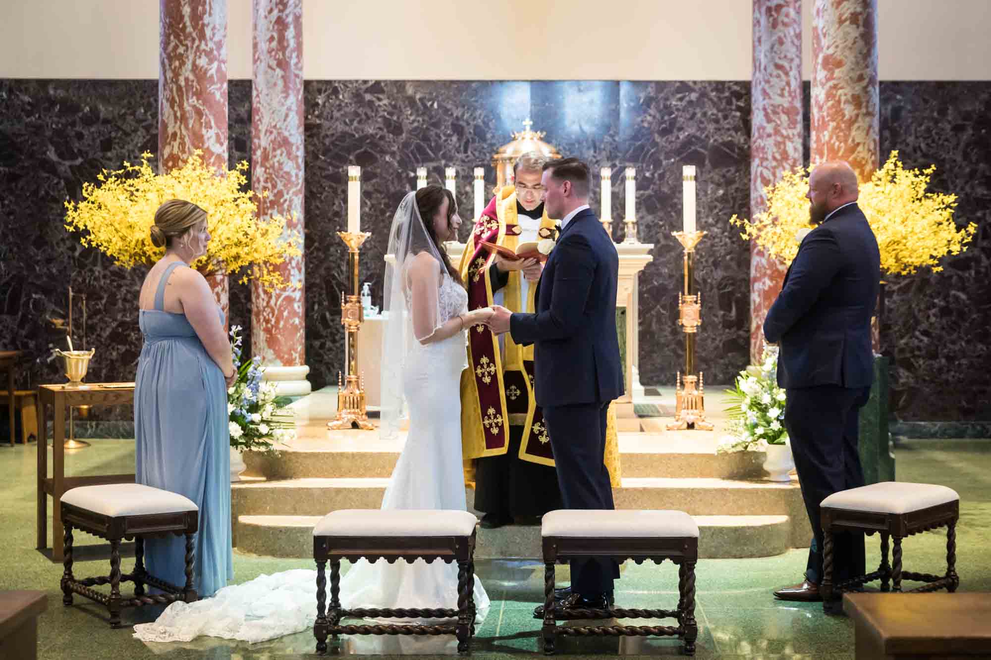 Bride and groom exchanging vows in church