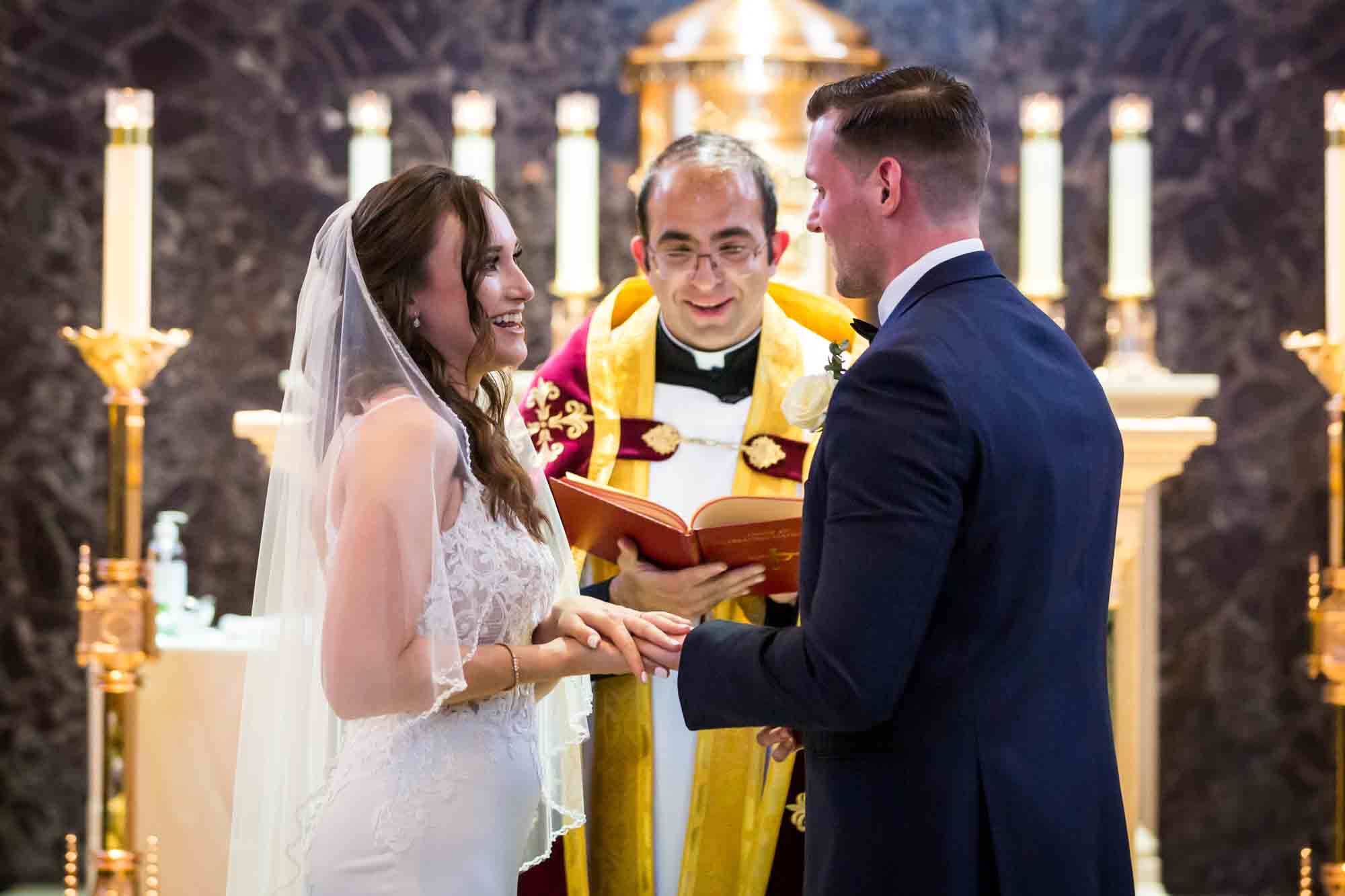 Bride and groom exchanging rings in church