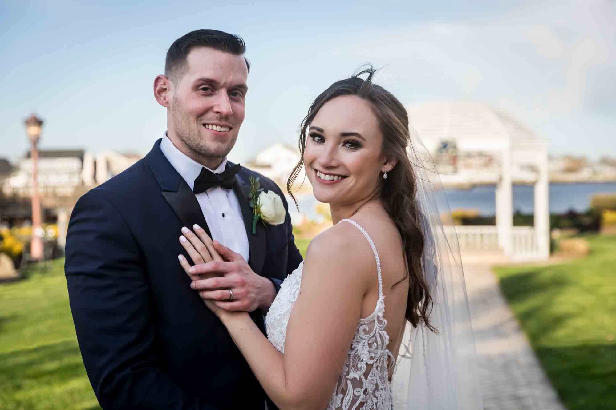 Riviera Waterfront Mansion wedding photos of groom holding bride's hand