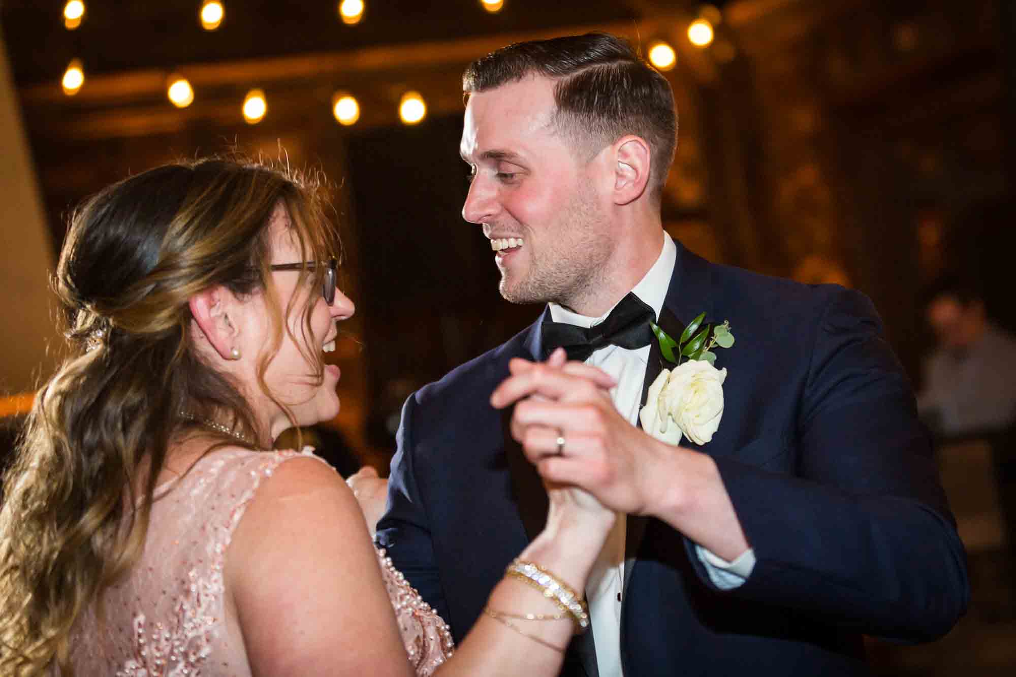 Groom and mother dancing at Riviera Waterfront Mansion wedding