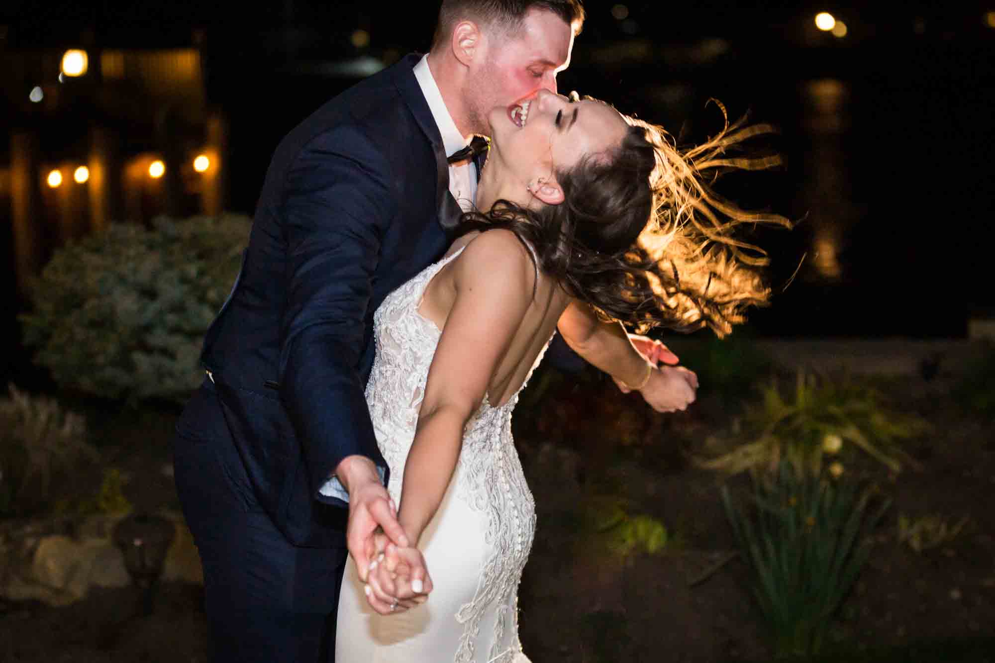 Bride and groom outdoors at night with dramatic lighting 