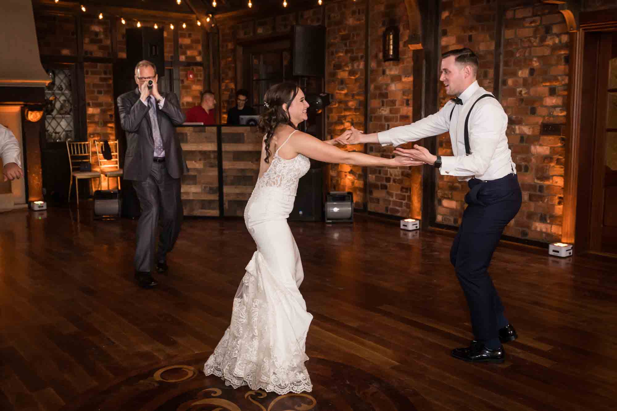 Bride and groom dancing in front of singer at Riviera Waterfront Mansion wedding