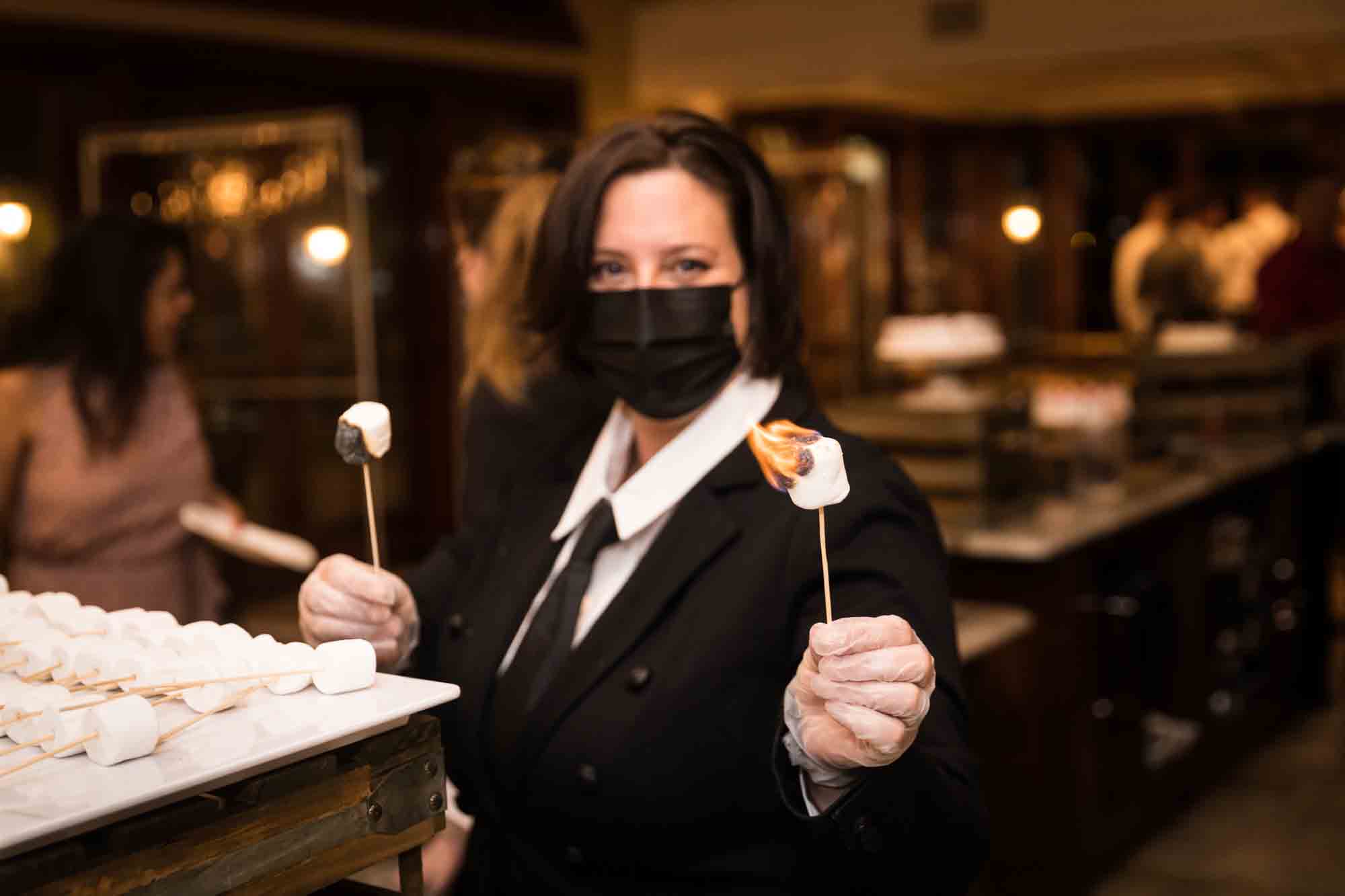 Waitress holding flaming marshmallows