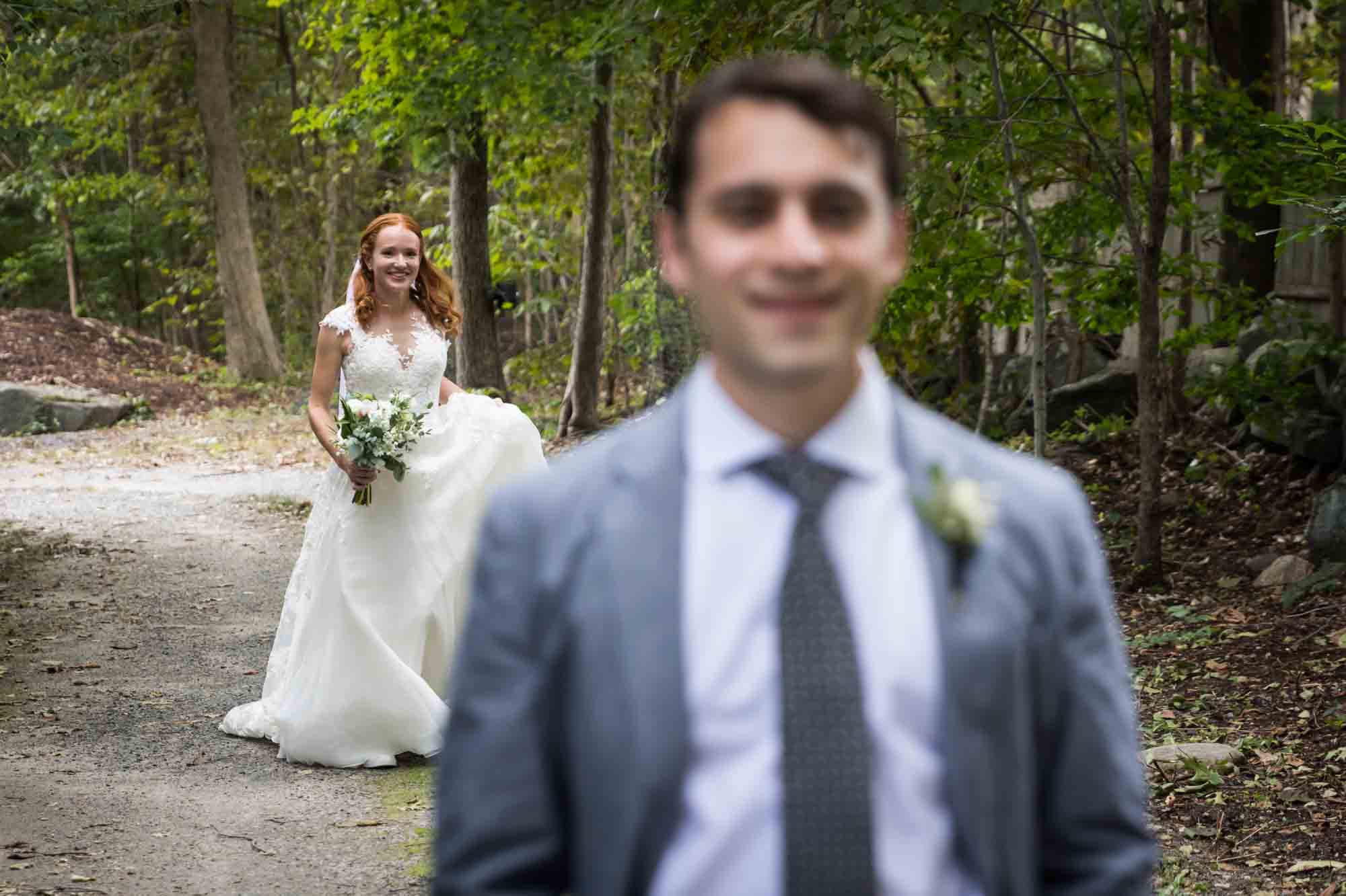 Bride approaching groom for first look for an article on backyard wedding tips