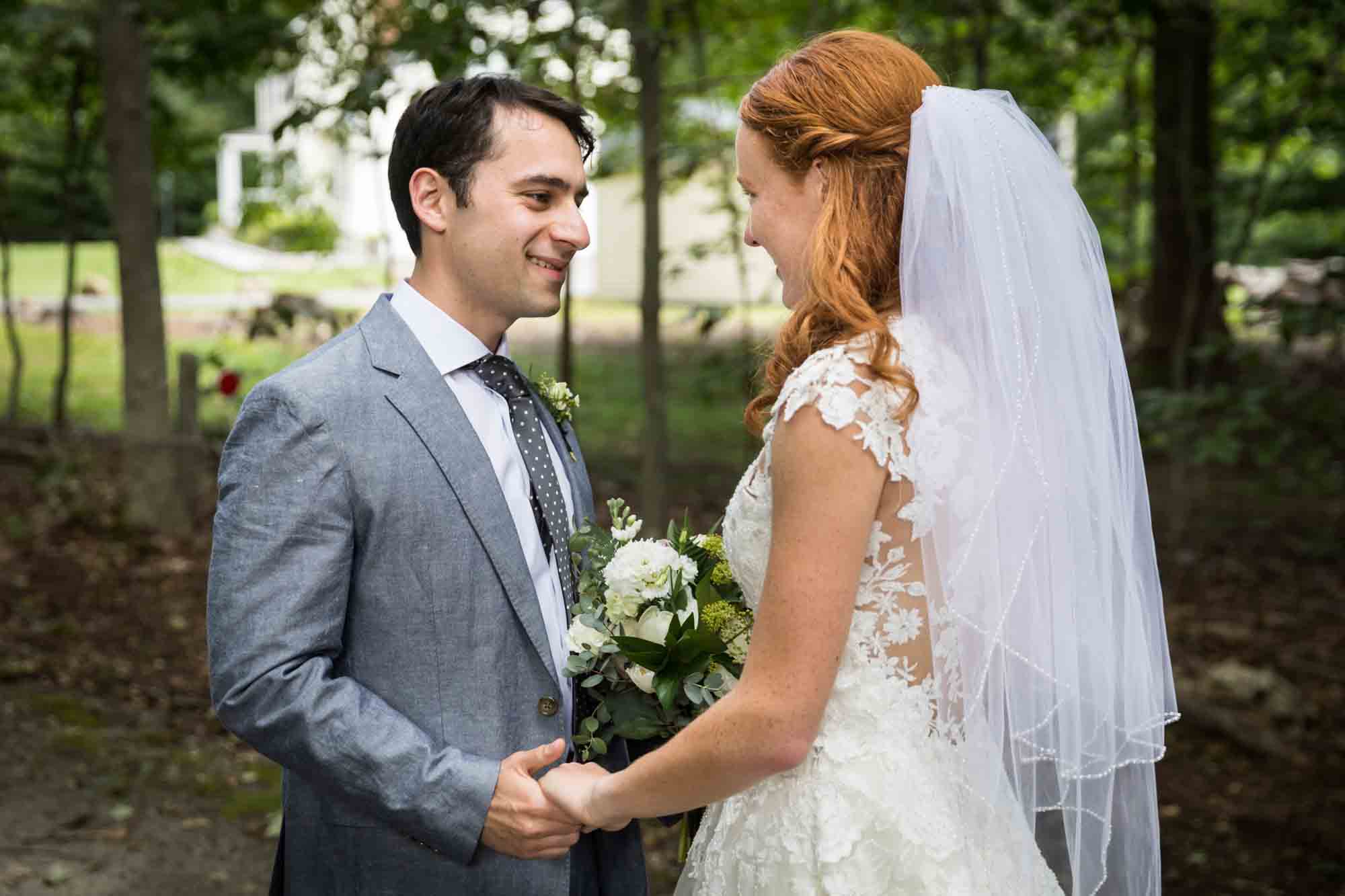 Bride and groom holding hands after first look for an article on backyard wedding tips