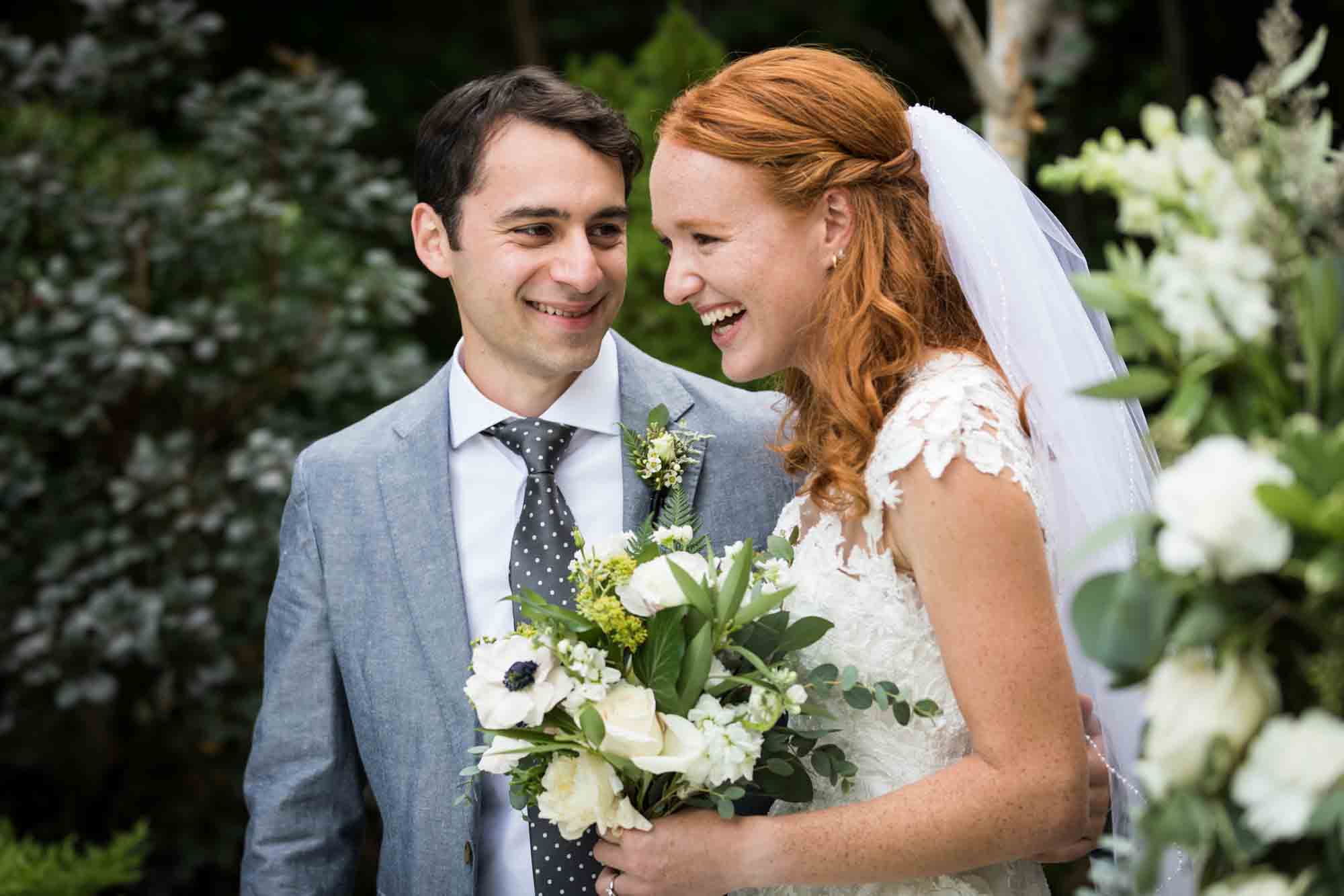 Bride and groom laughing for an article on backyard wedding tips