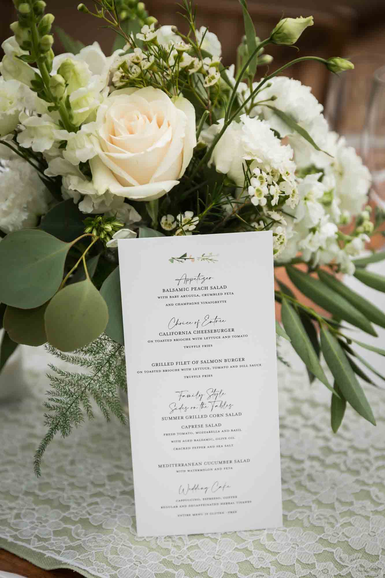 Menu card in front of white flower bouquet