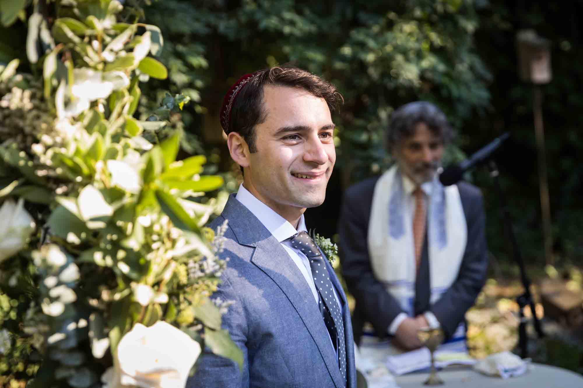 Groom waiting for bride at ceremony for an article on backyard wedding tips