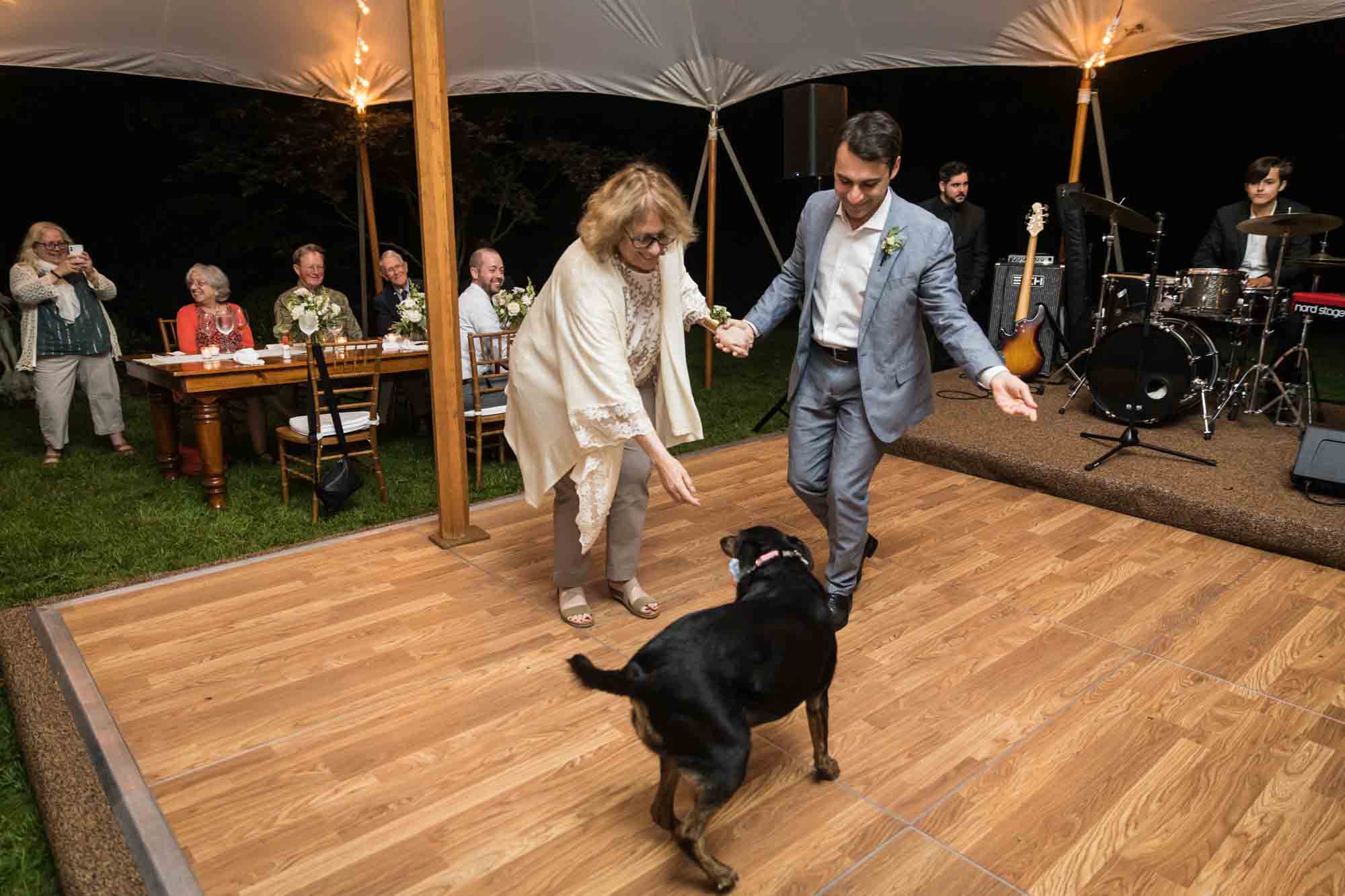 Mother and son dancing with dog for an article on backyard wedding tips