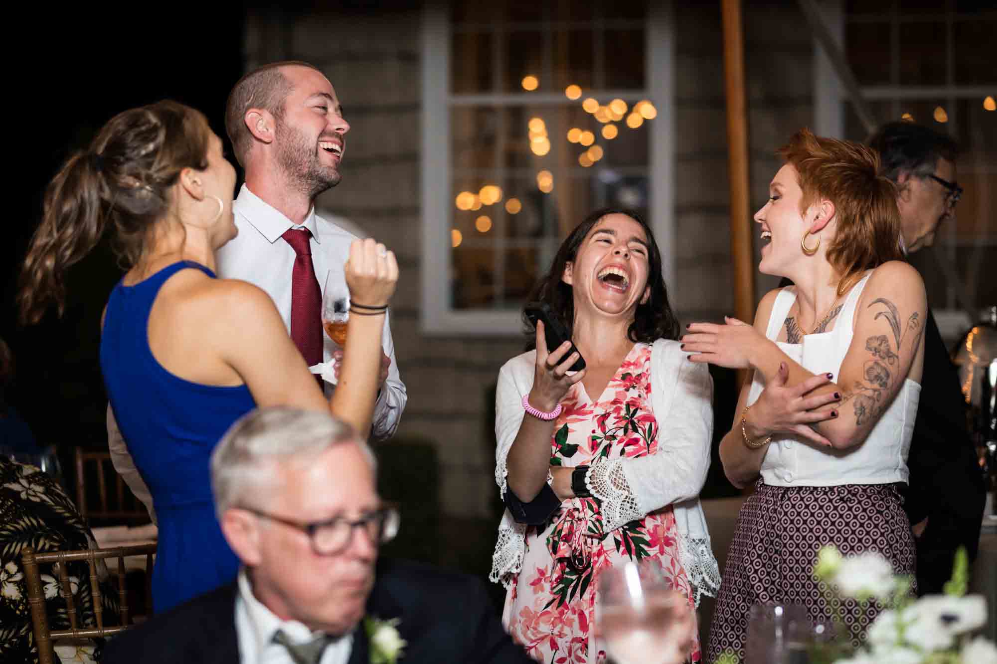 Guests laughing wildly for an article on backyard wedding tips