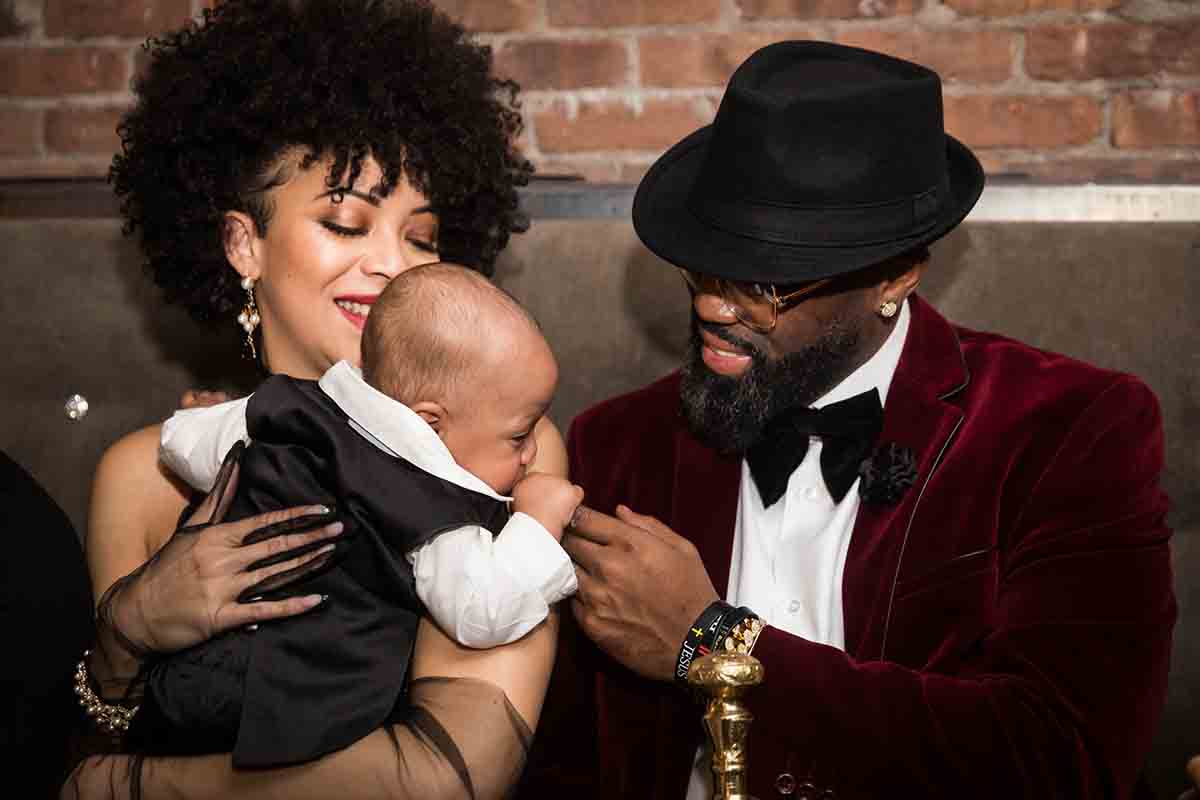 African American couple playing with baby at a Deity wedding