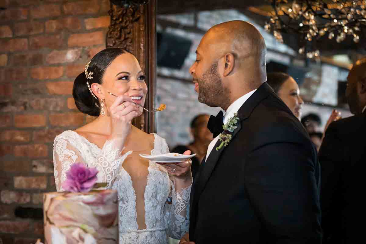 Bride feeding cake to groom at a Deity wedding